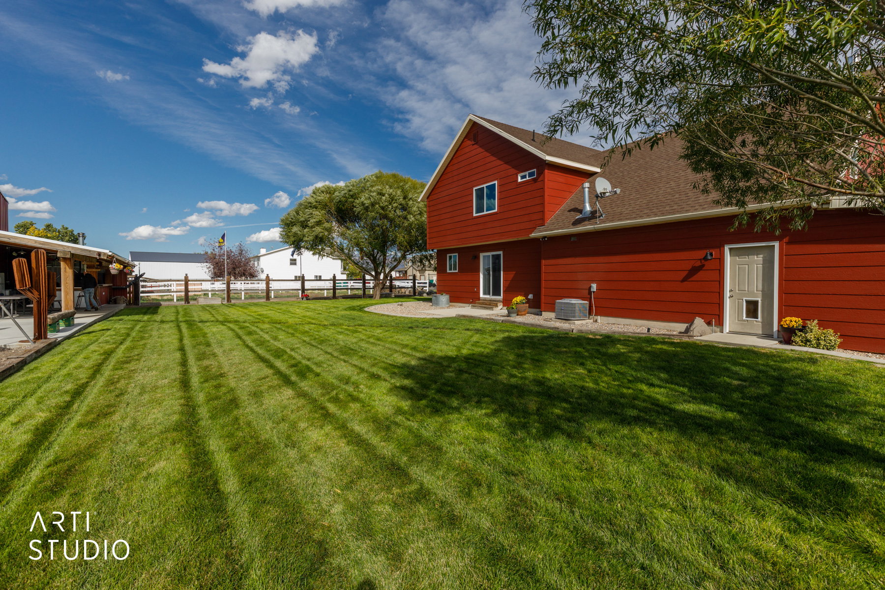 Expansive green lawn with defined mowing patterns