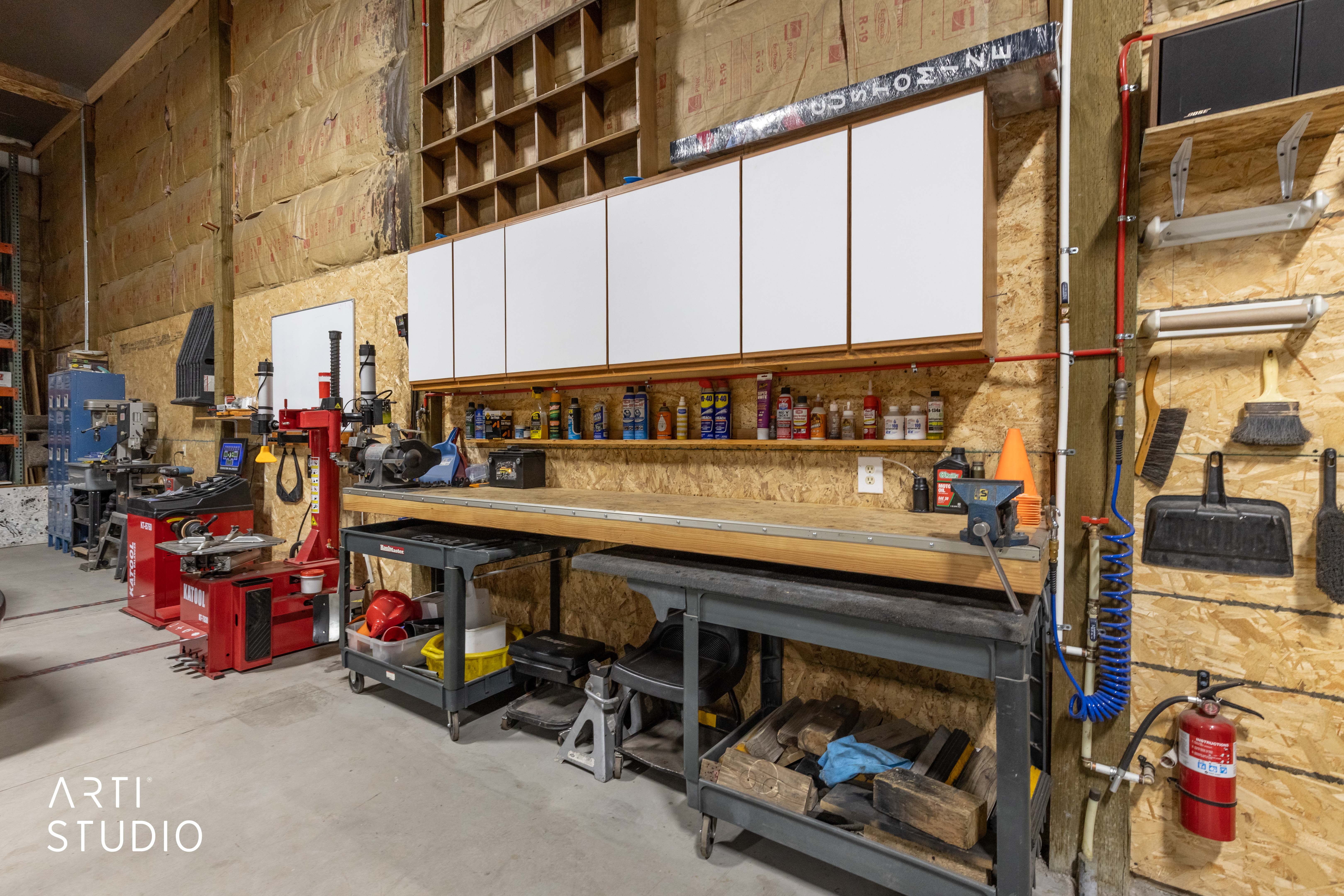 Industrial workshop area featuring exposed insulation walls and concrete flooring