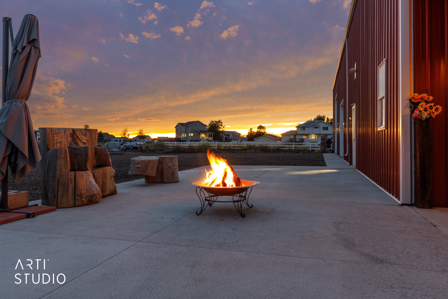 Spacious concrete patio featuring a fire pit
