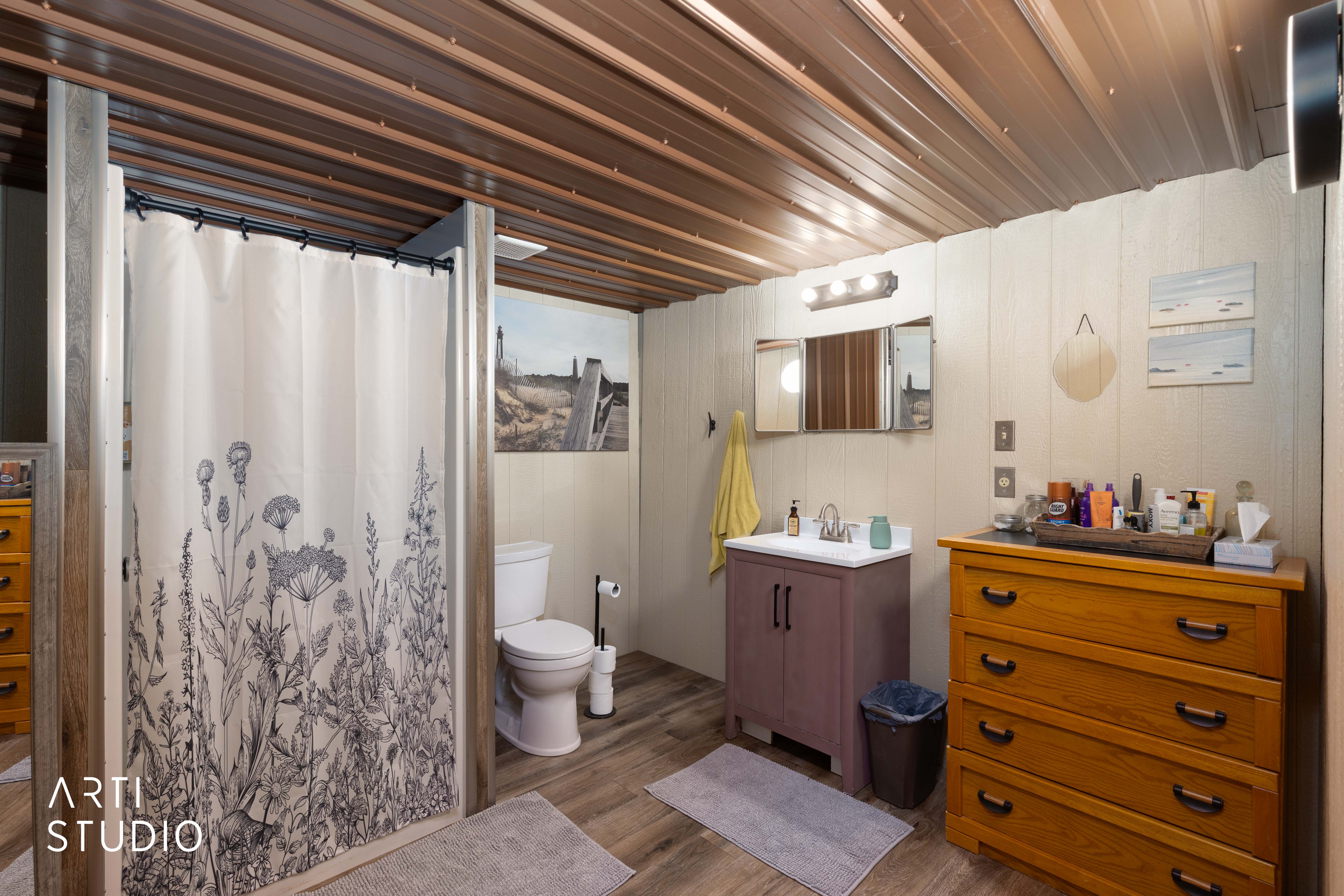 Bathroom featuring LVP flooring and a corrugated metal ceiling