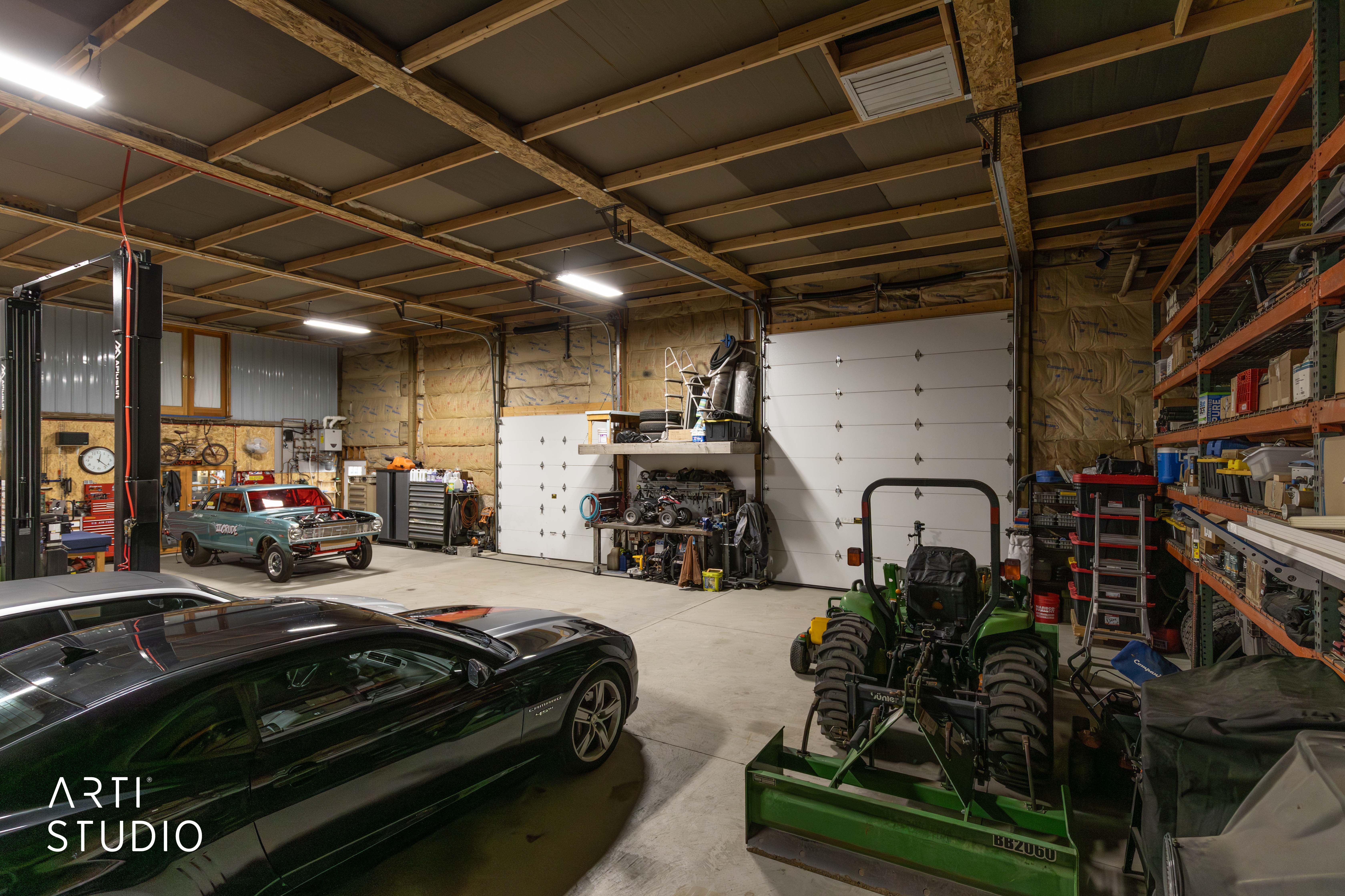 Spacious garage featuring concrete flooring and exposed wood beam ceiling