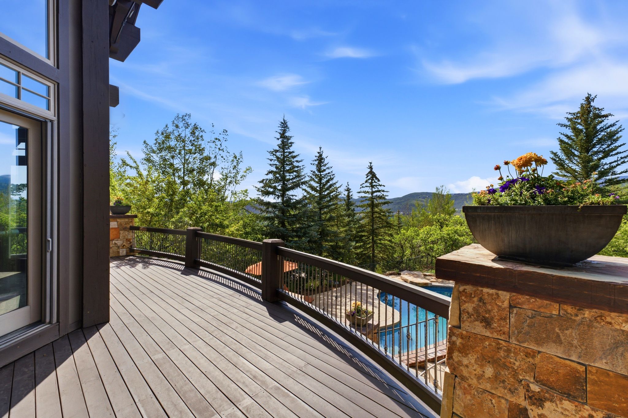 Expansive outdoor deck with composite flooring and dark wood railing