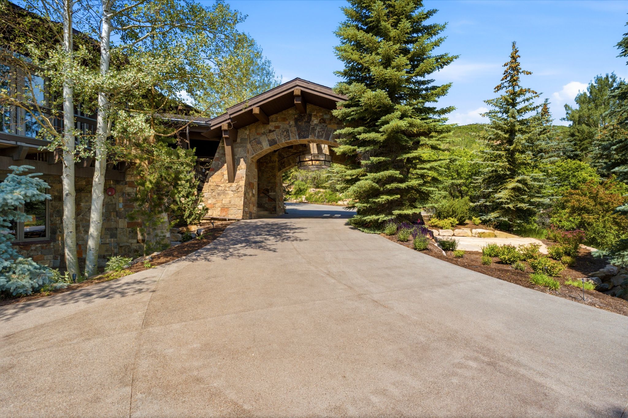 Stone archway porte-cochère with exposed timber accents