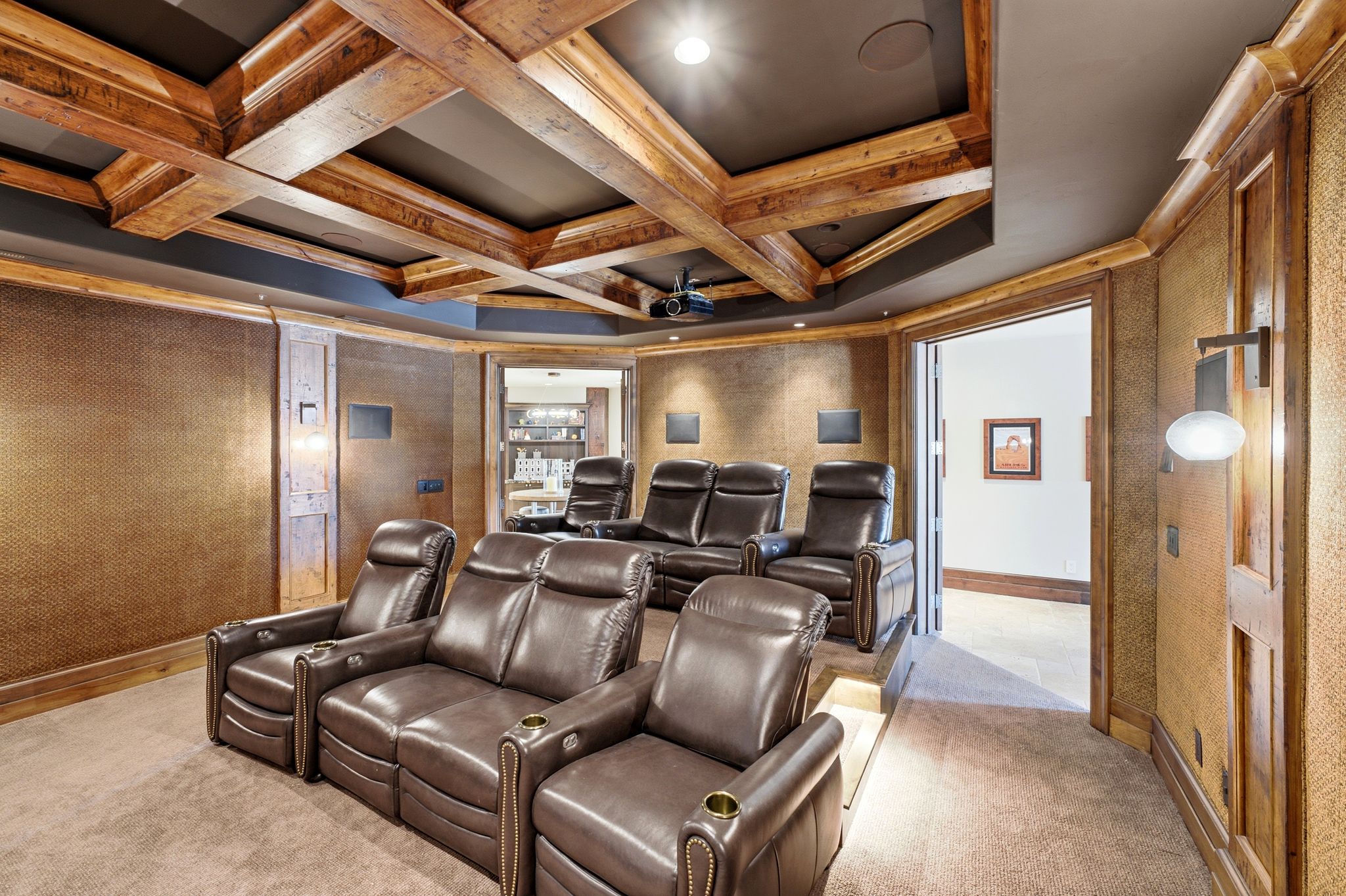 Dedicated media room featuring tiered seating on carpeted flooring