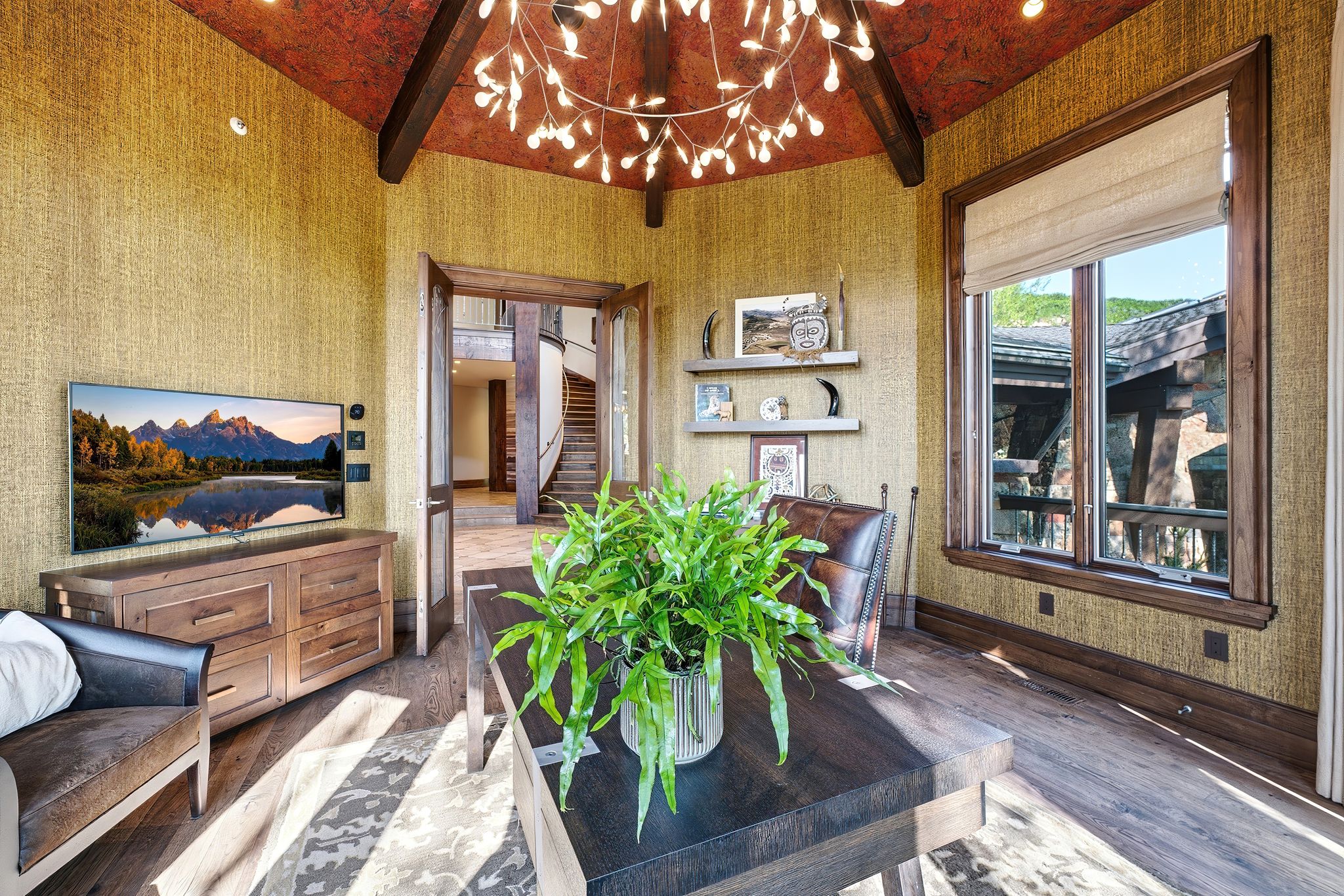 Wood-finish flooring anchors this room featuring textured wall coverings and a decorative ceiling