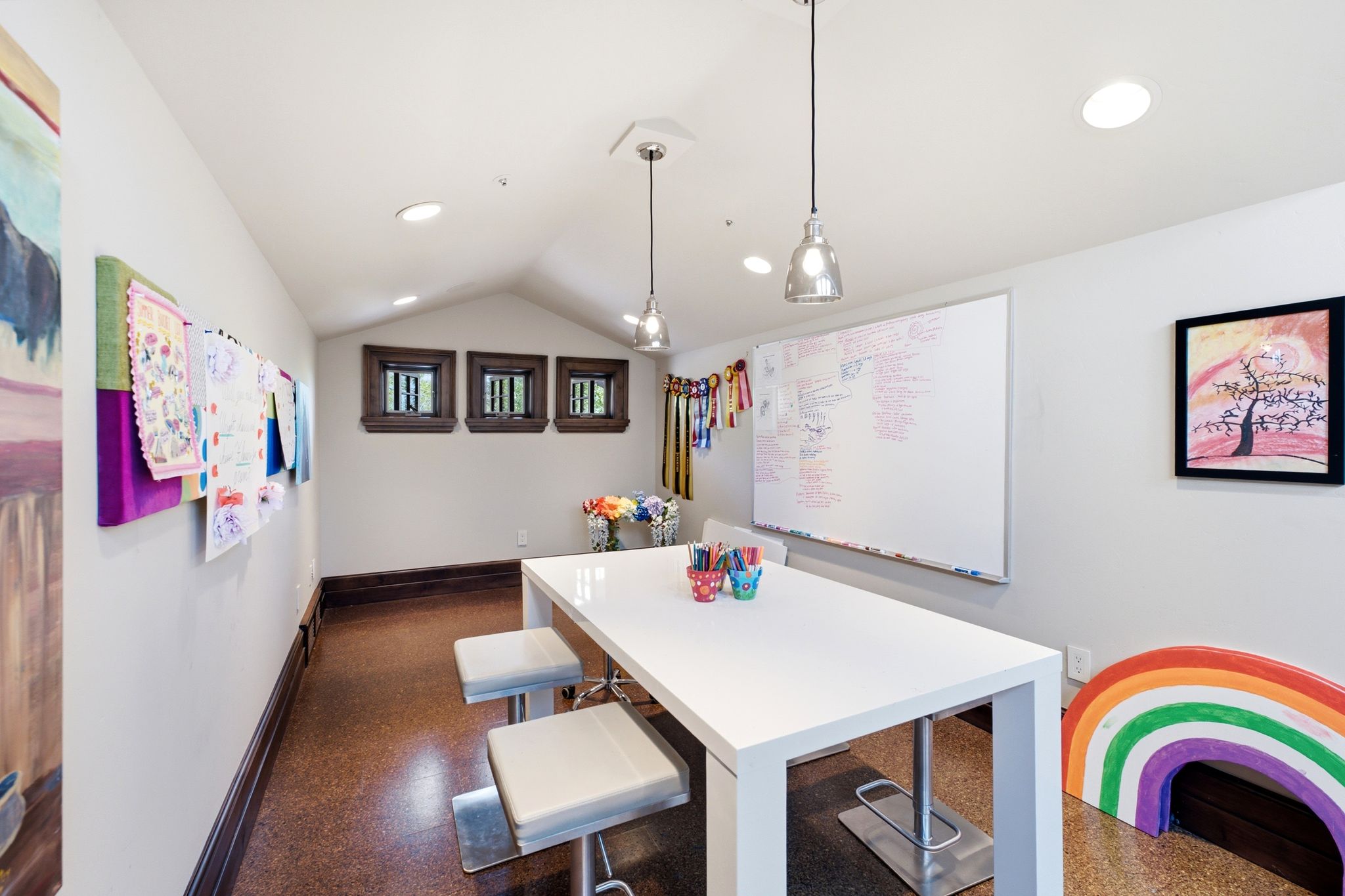Room featuring sloped ceilings, recessed lighting, and a durable cork-finish floor