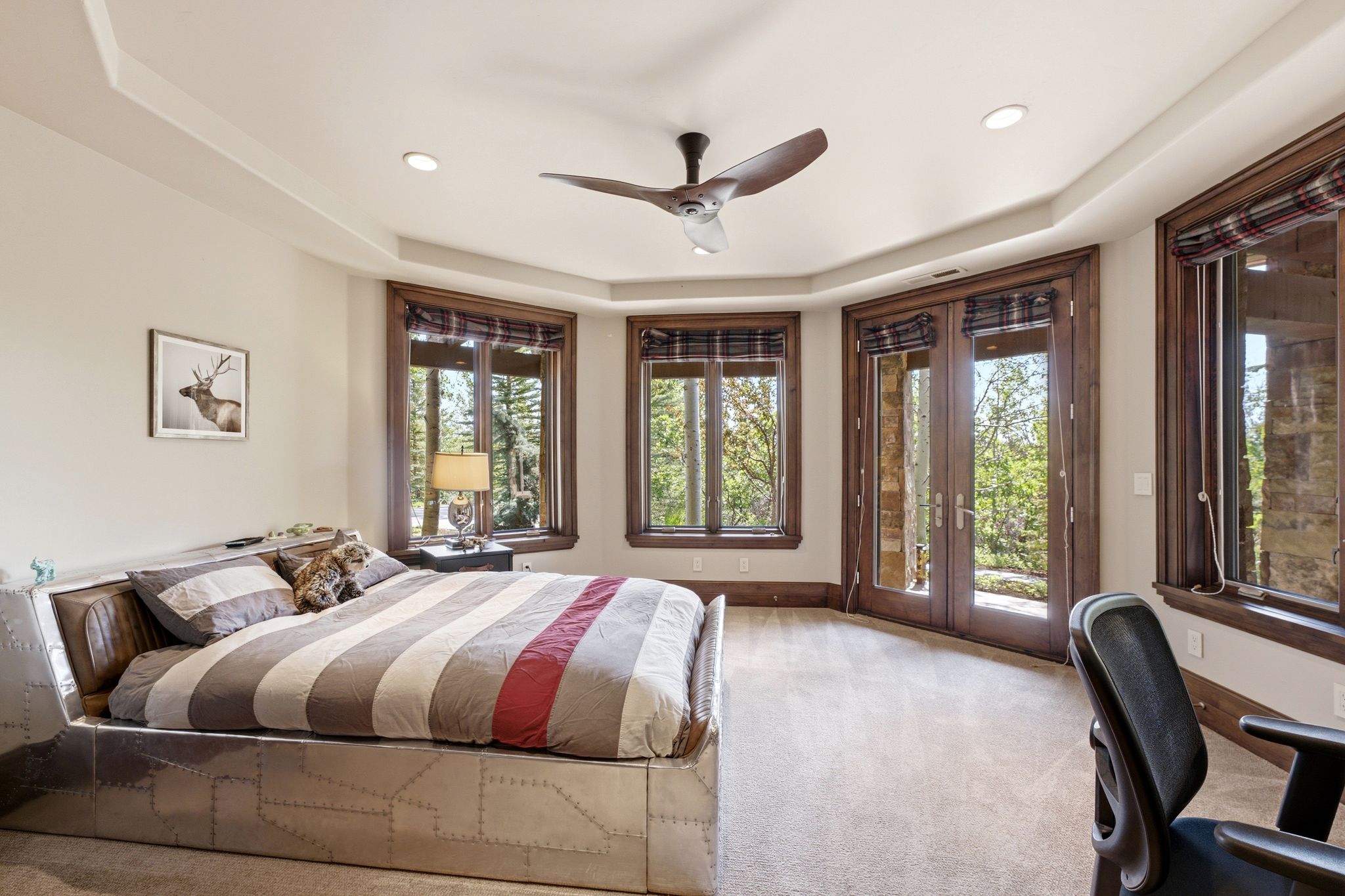 Bedroom with tray ceiling, recessed lighting, and a dark wood-finish ceiling fan