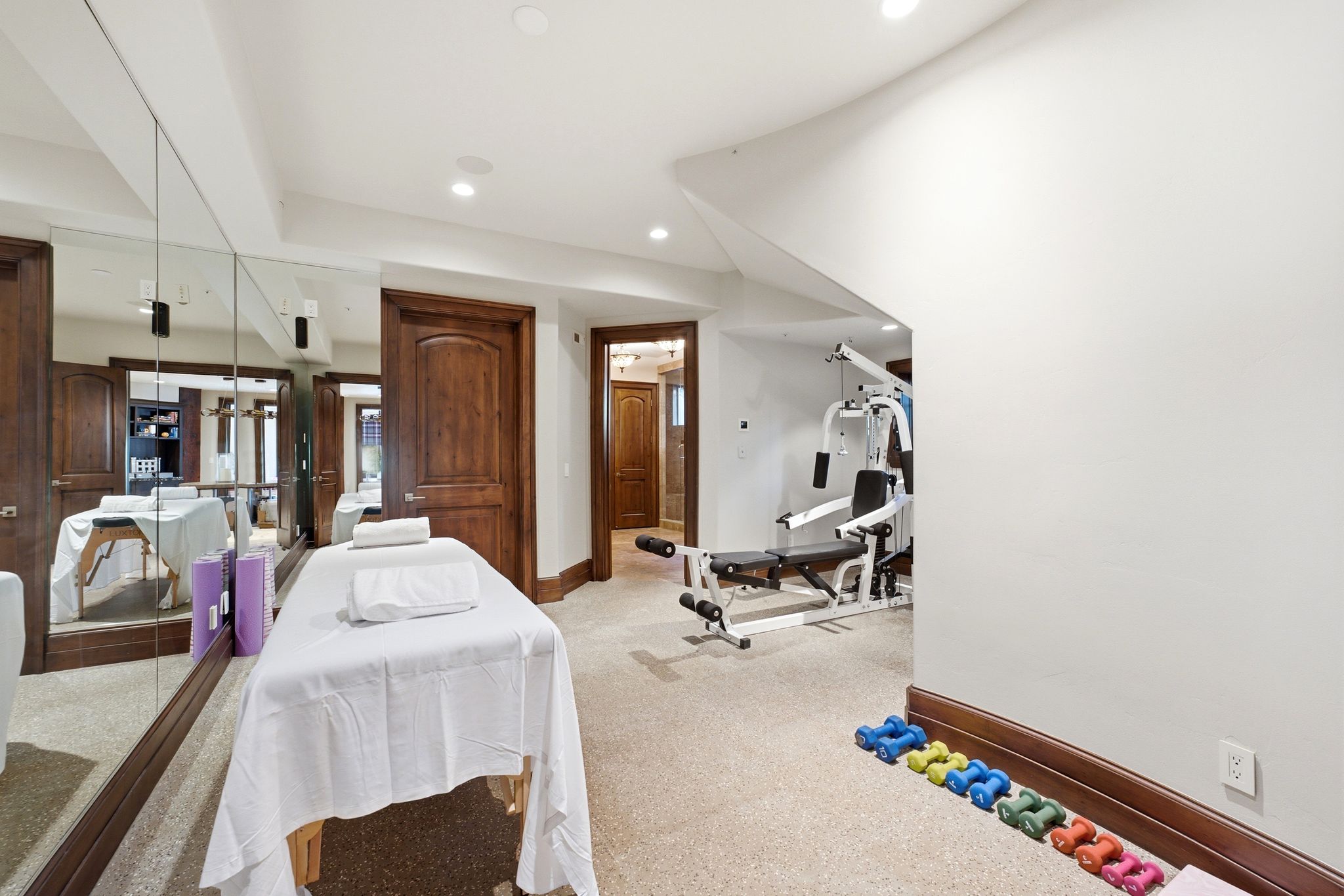Carpeted recreation room featuring full-wall mirrors and recessed lighting