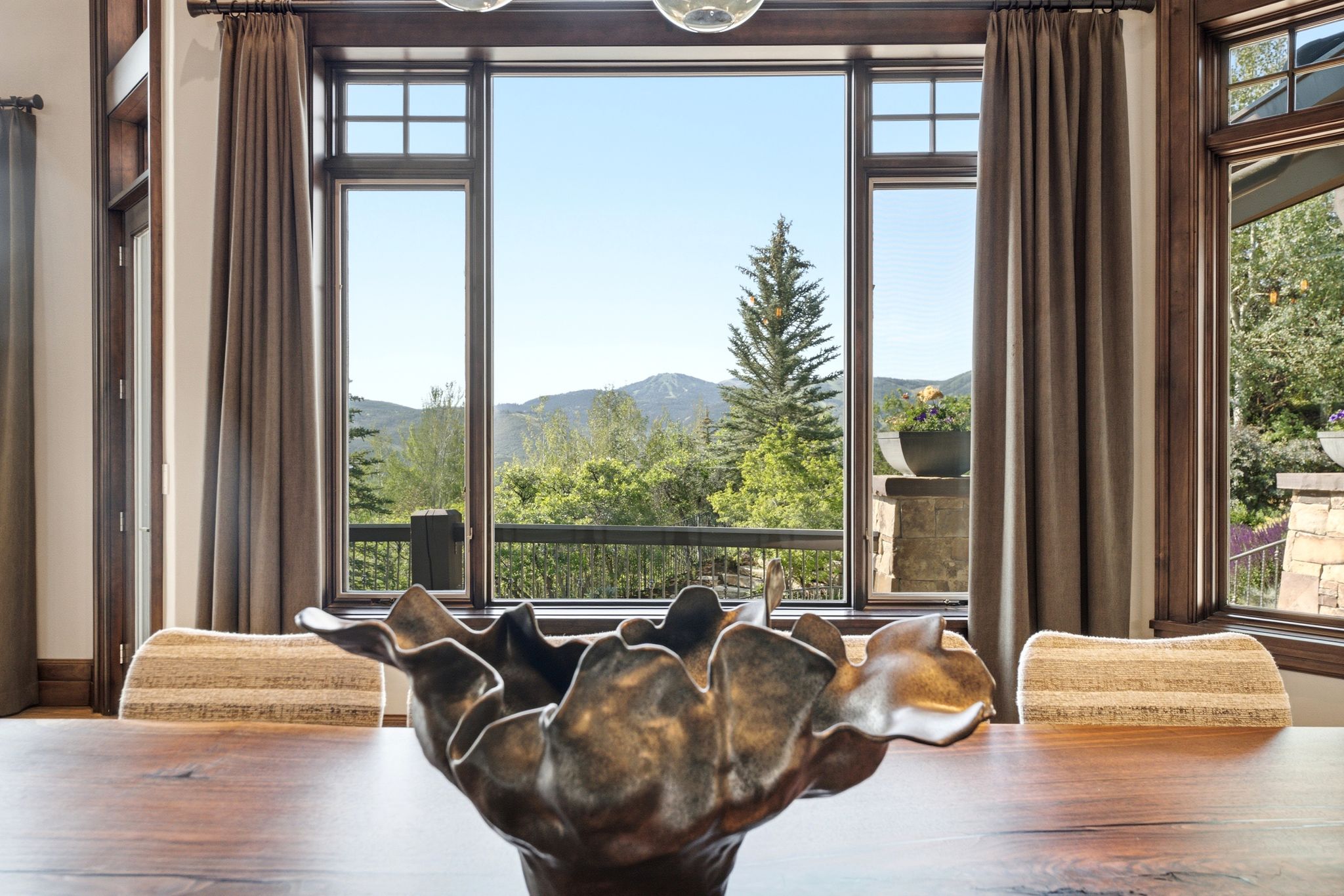 Expansive multi-pane windows with dark wood framing