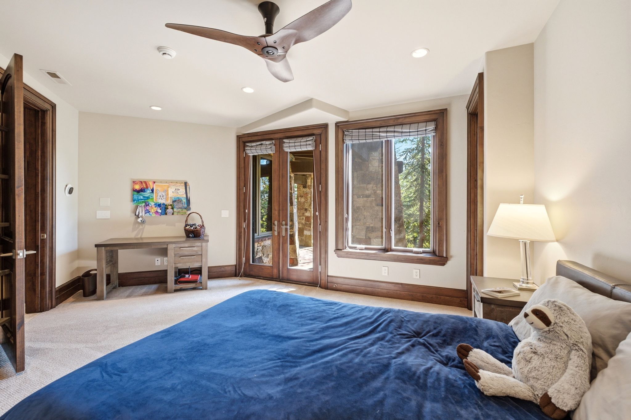 Carpeted room featuring a ceiling fan, recessed lighting, and a built-in desk with drawers