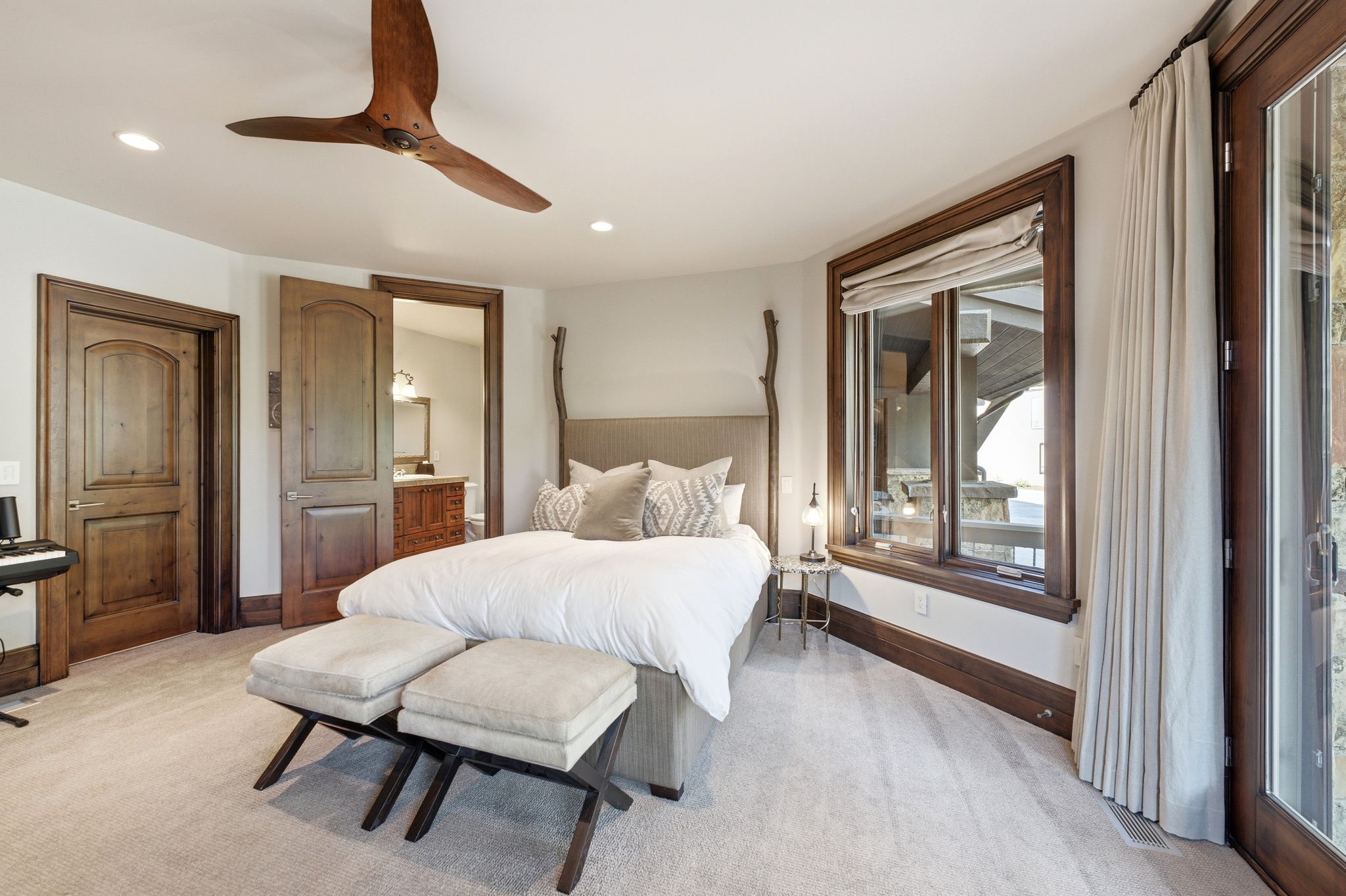 Carpeted room with recessed lighting and a wood-finish ceiling fan