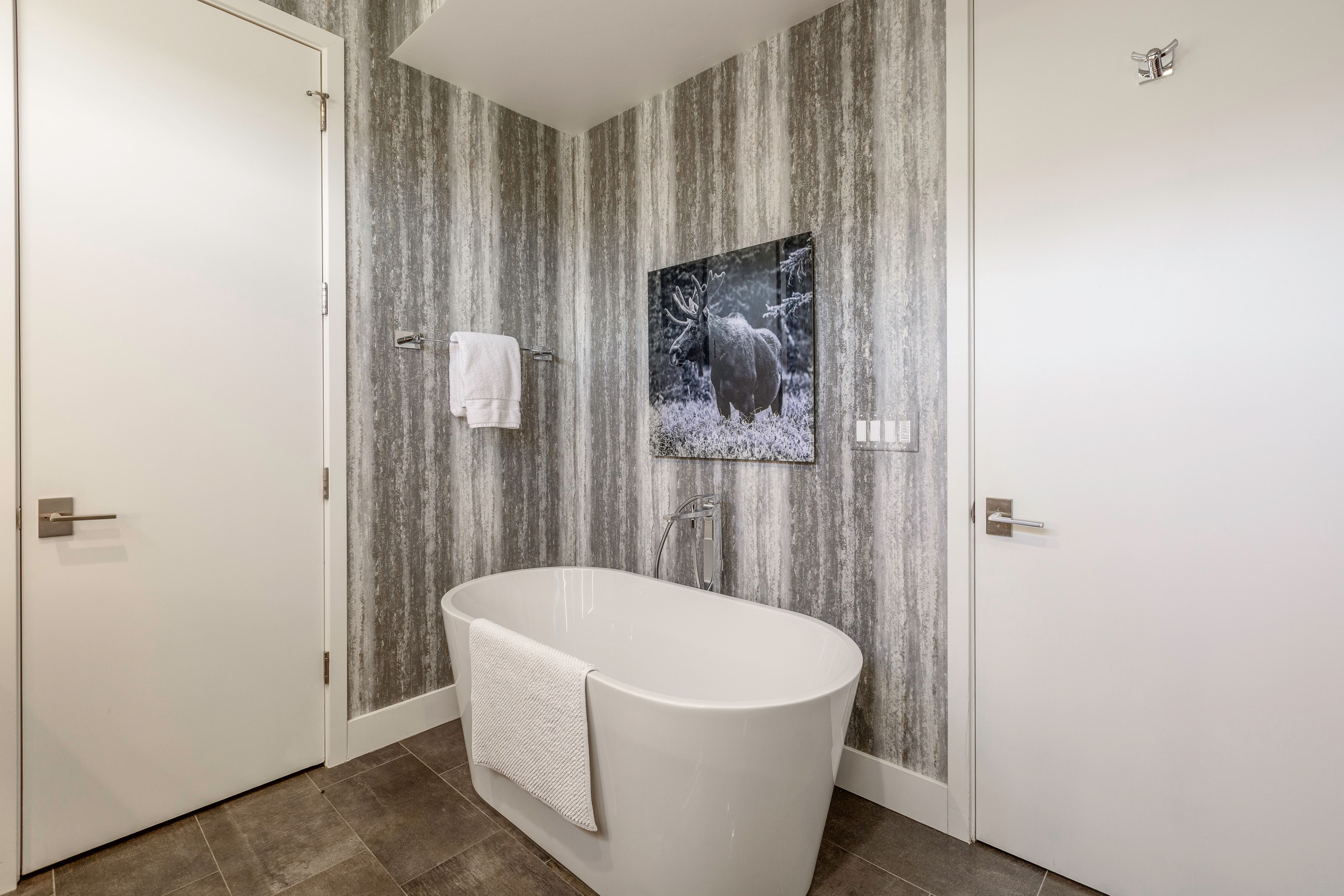 Freestanding soaking tub with floor-mounted faucet