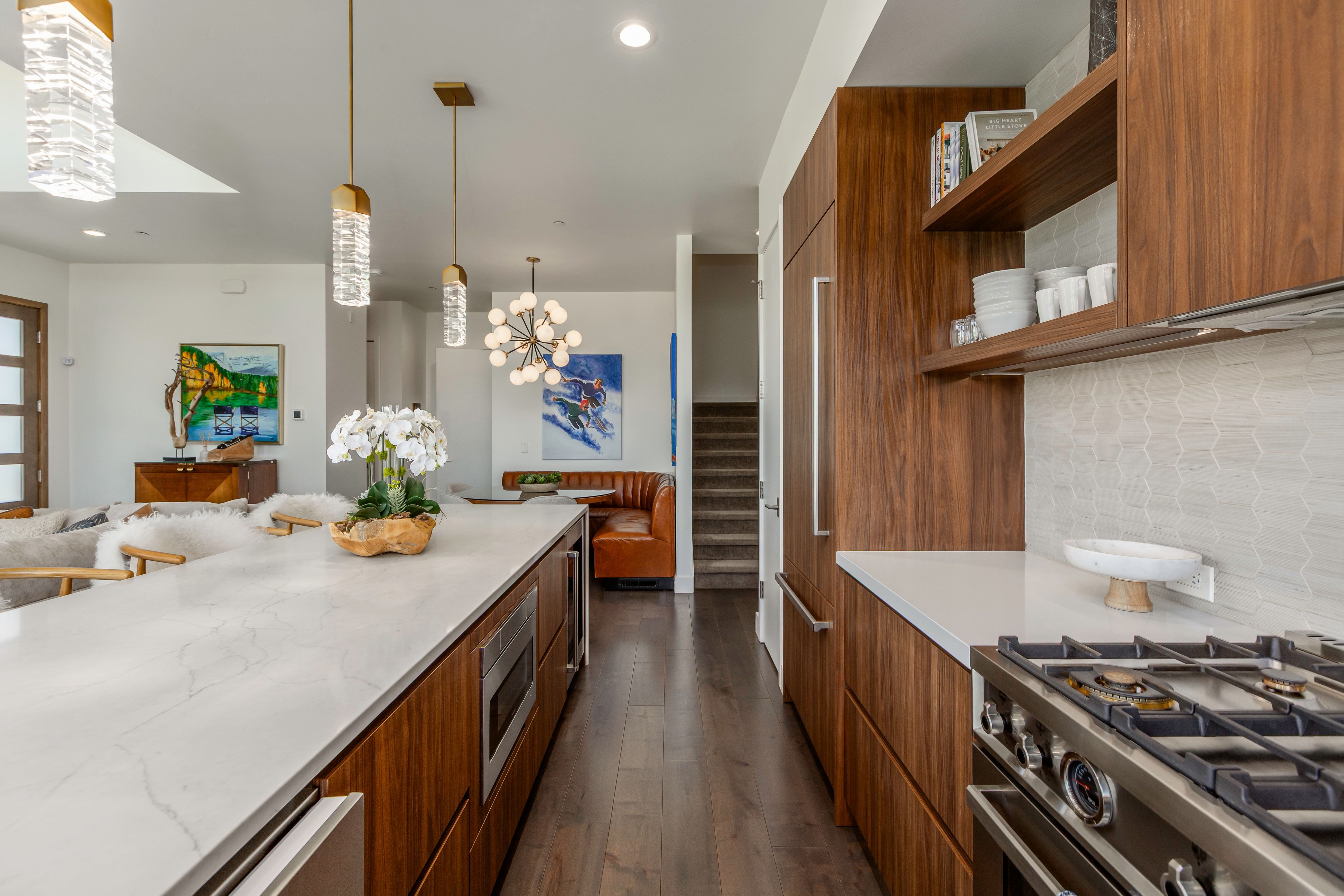 Gourmet kitchen featuring a gas range, integrated refrigerator, and wood-finish cabinetry