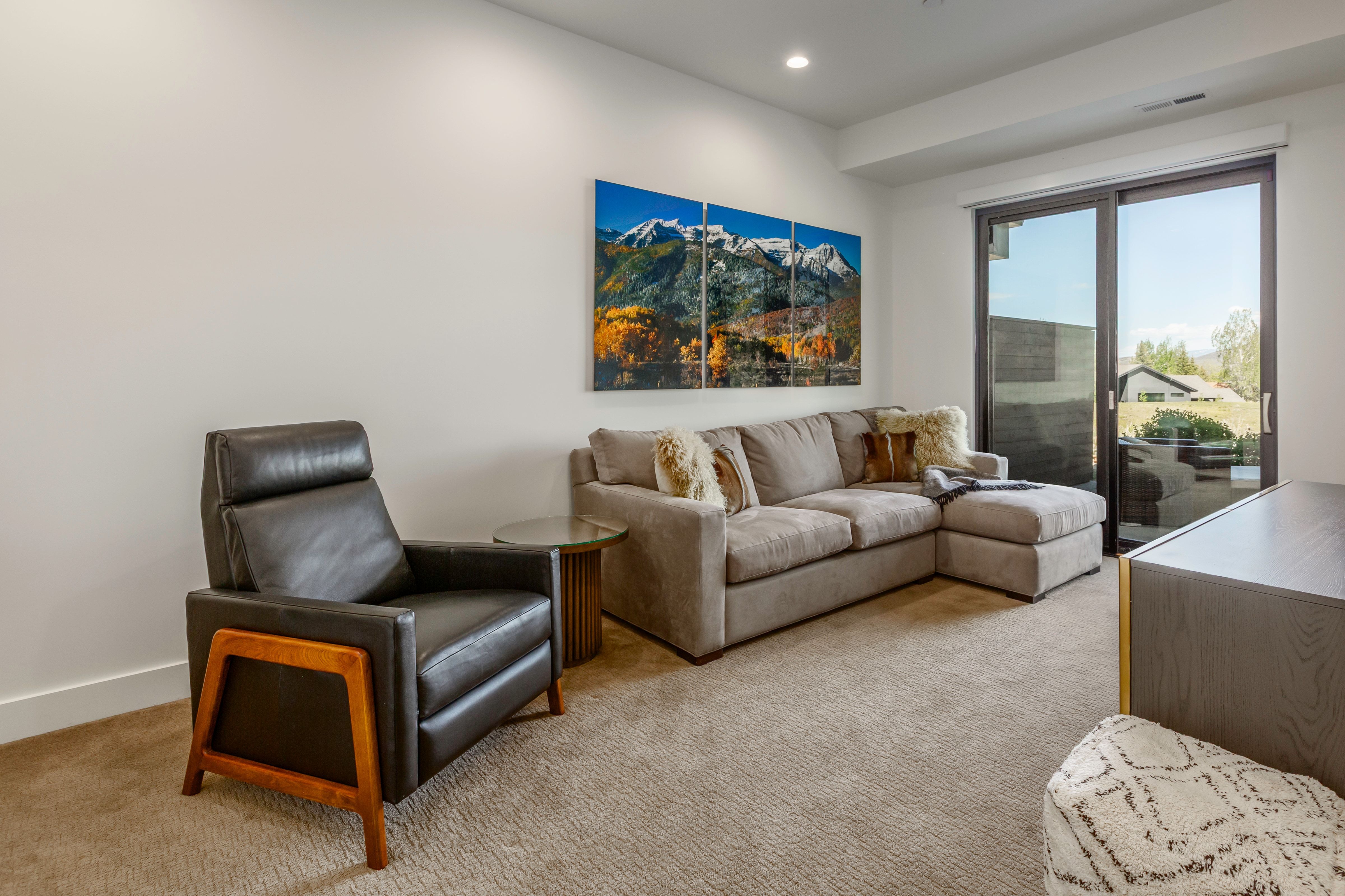 Carpeted room featuring a large sliding glass door, recessed lighting, and white walls