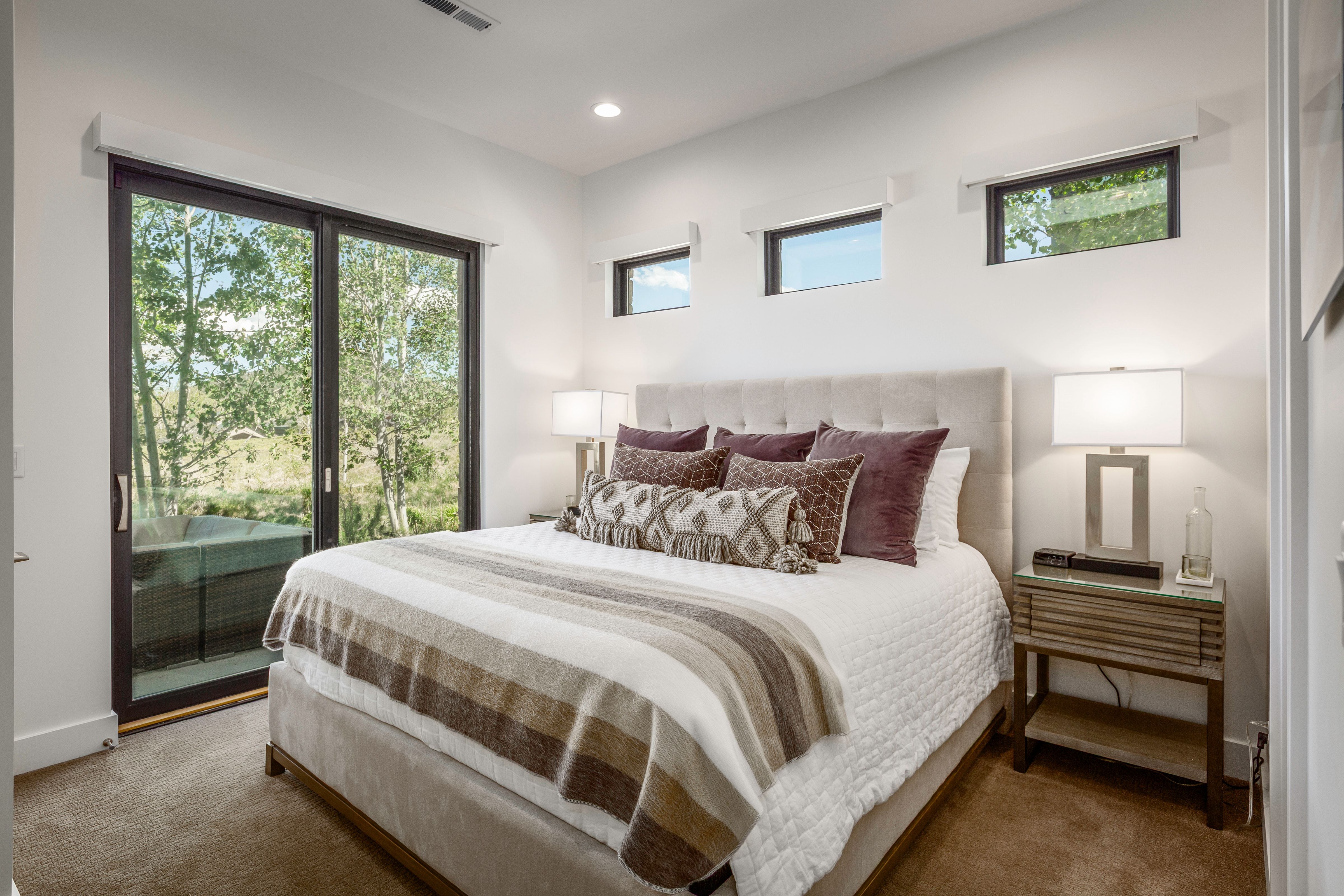 Expansive sliding glass doors open to outdoor space