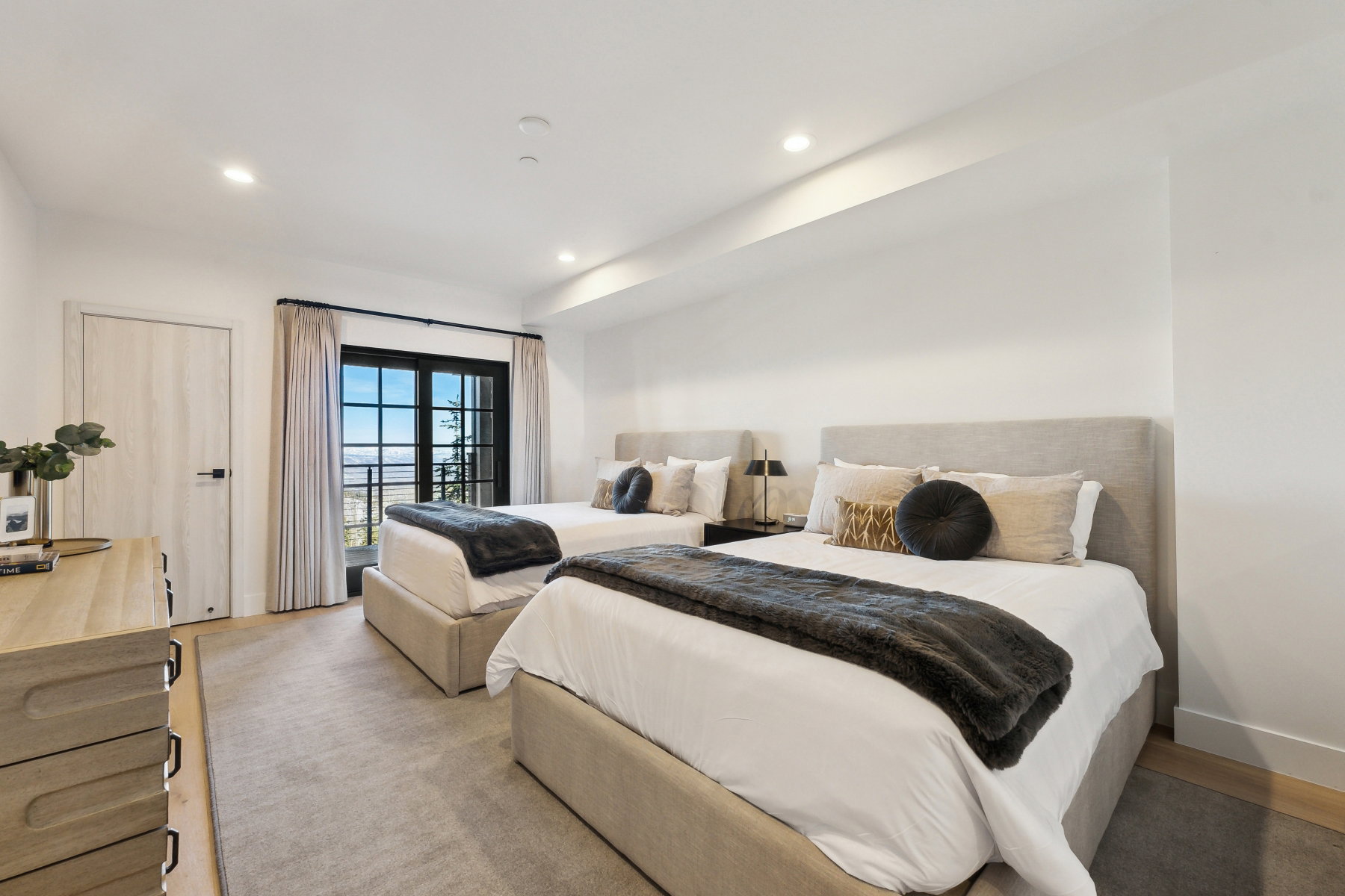 Bedroom with recessed lighting, wood-finish flooring, light-toned carpeting, and a full-light door with exterior scenery