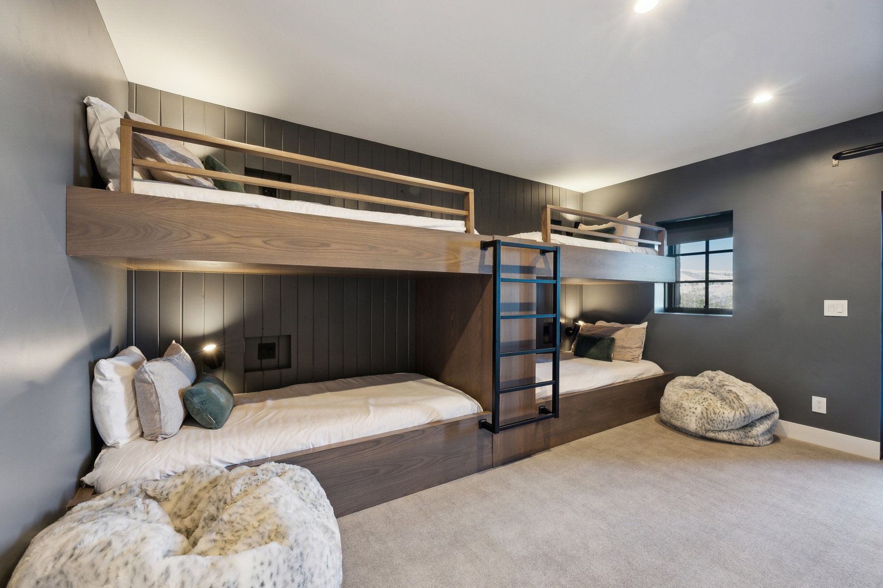 Built-in bunk beds featuring wood-finish construction and integrated wall lighting