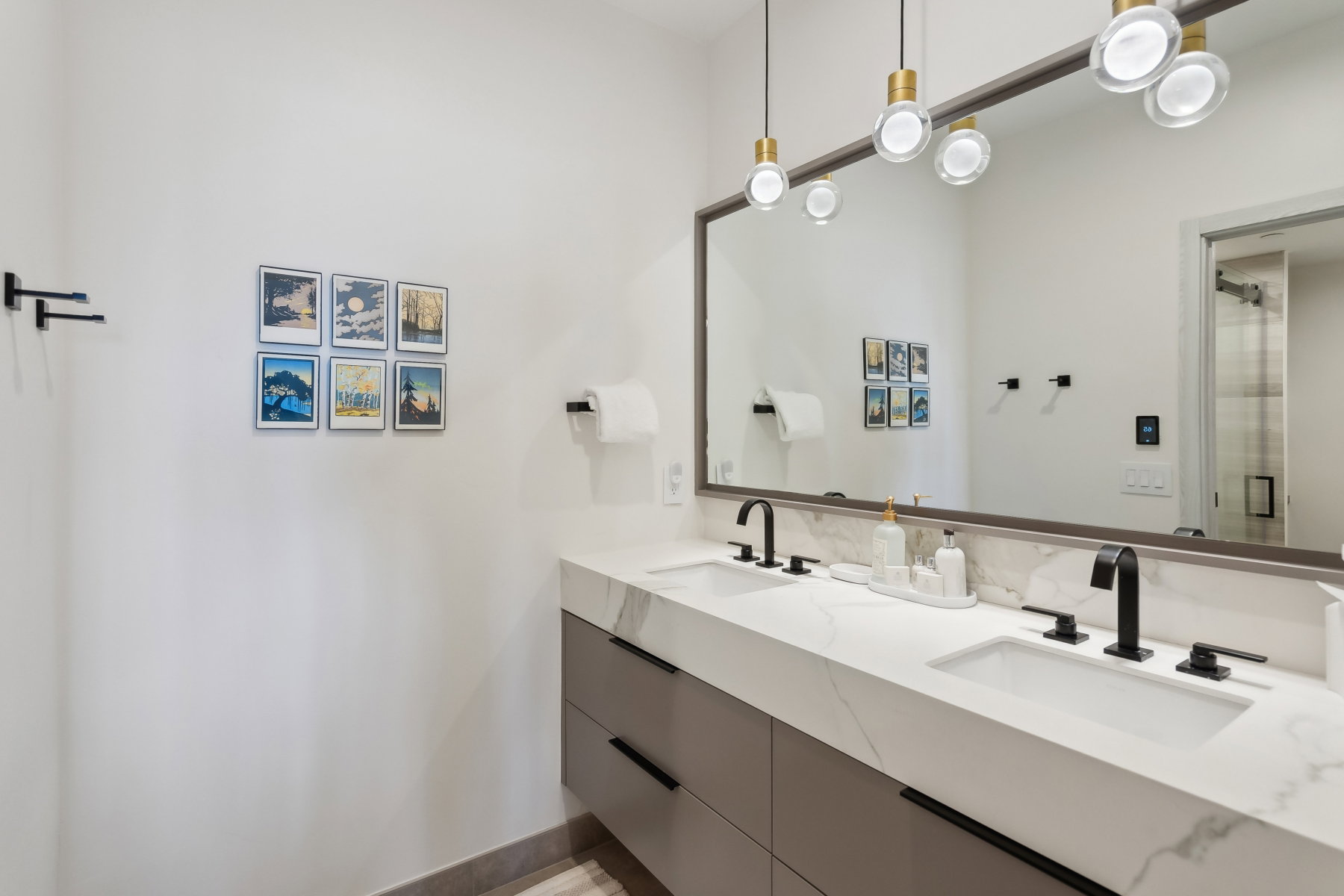 Dual vanity with integrated sinks, white marble-look countertop, and matte black fixtures