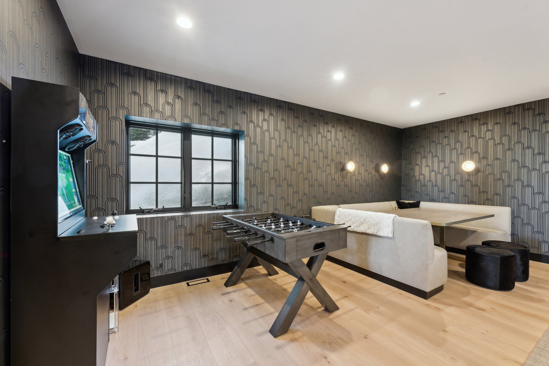Recreation room featuring hardwood flooring, recessed lighting, and a built-in banquette with sconce lighting