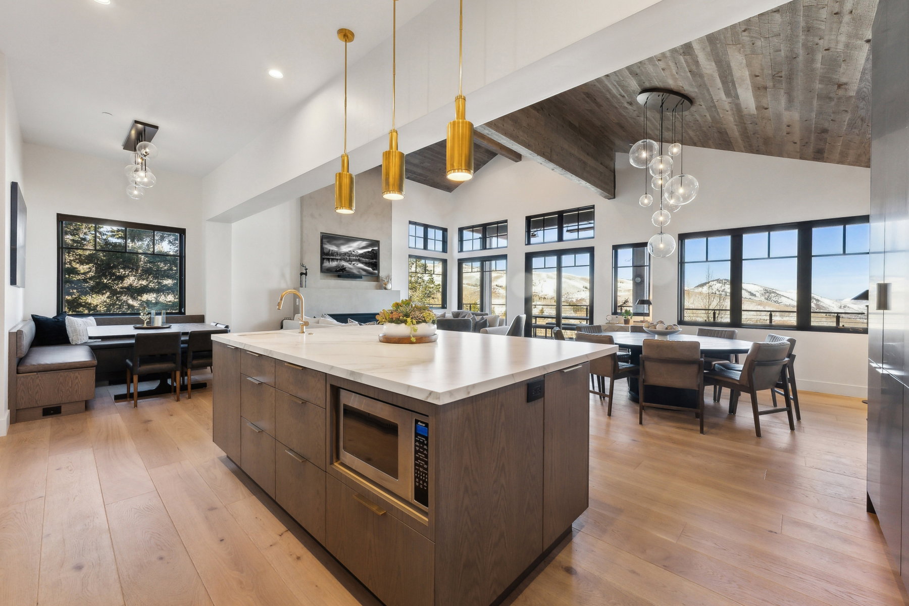 Spacious kitchen island with a light-toned countertop, integrated microwave, and ample storage cabinetry