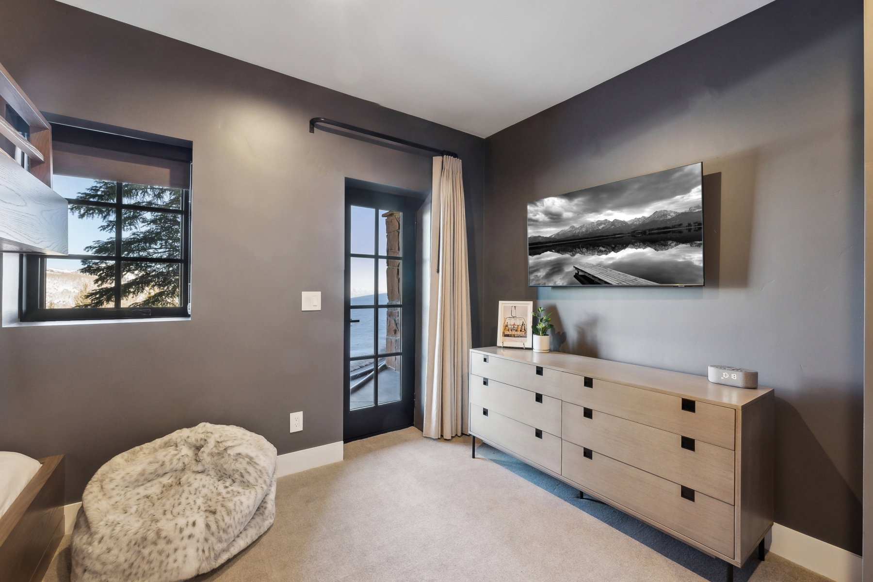 Room featuring dark gray walls and light-colored carpeting