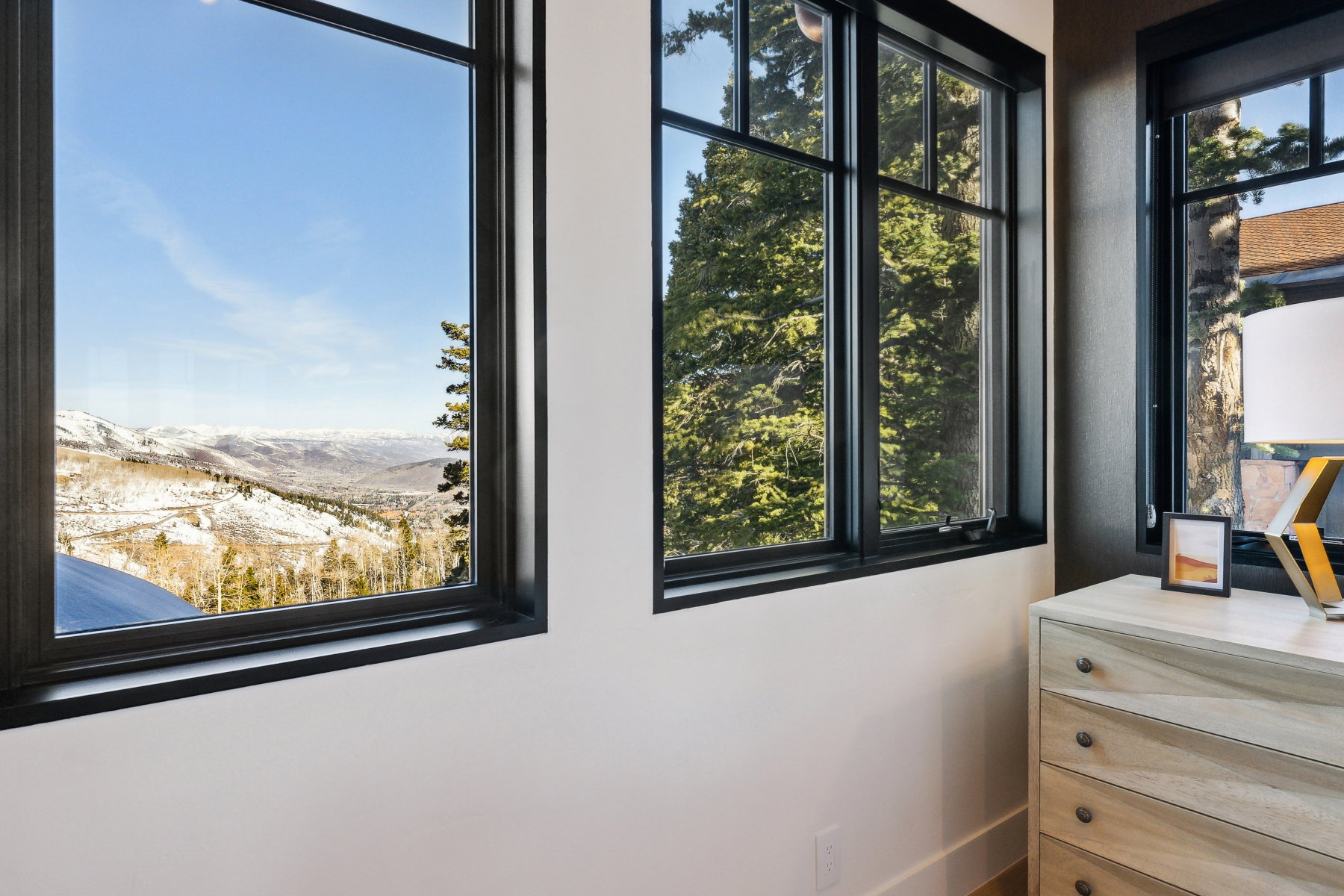 Expansive window framing a mountain and valley landscape