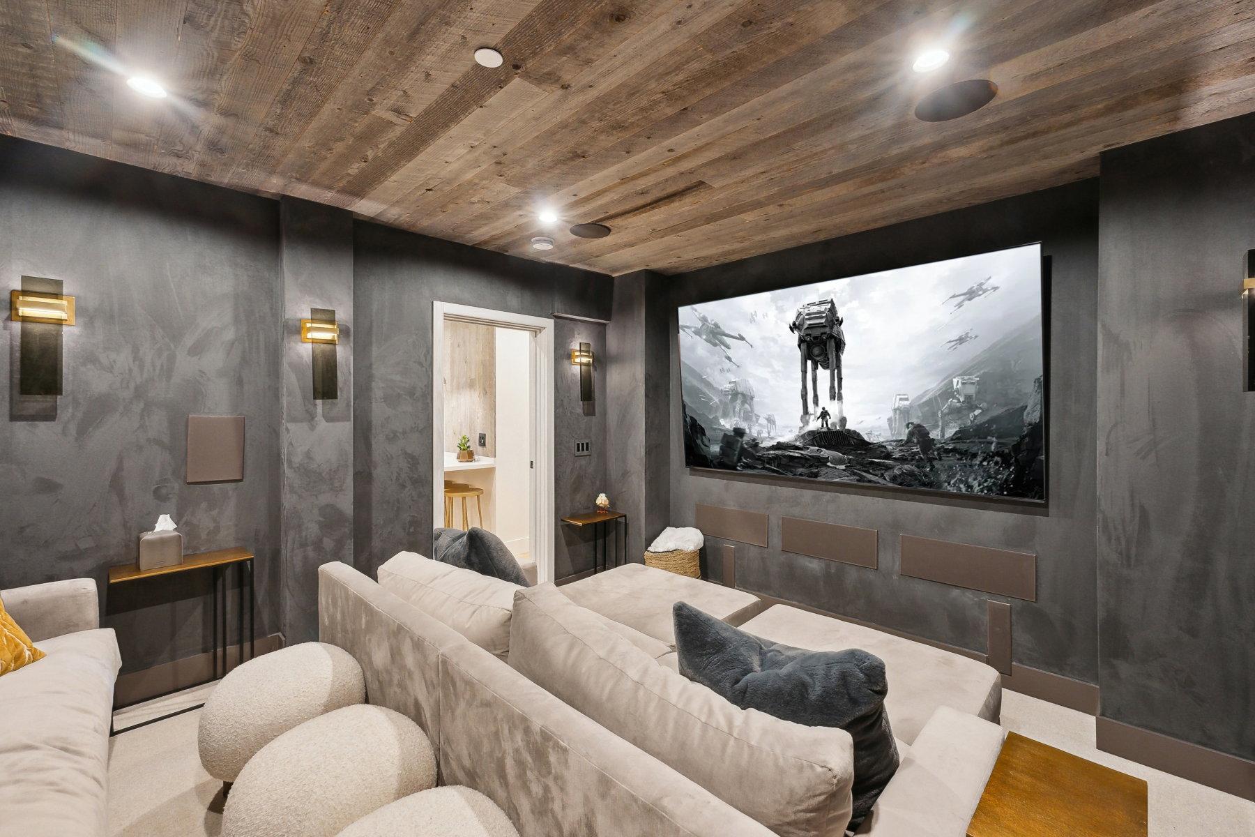 Home theater featuring a large screen, integrated speakers, recessed lighting, and a wood-finish ceiling