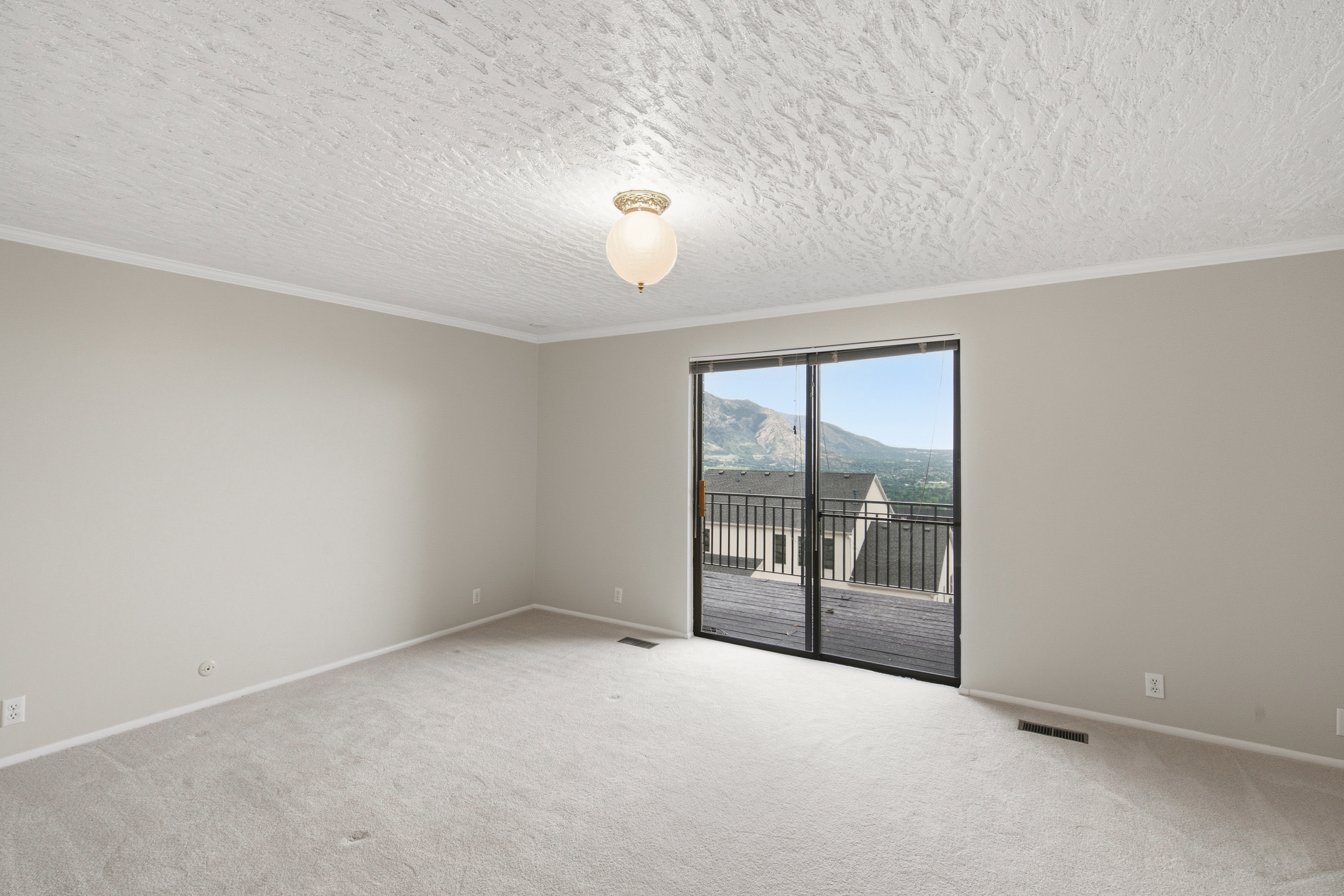 Room featuring a sliding glass door providing access to an outdoor balcony