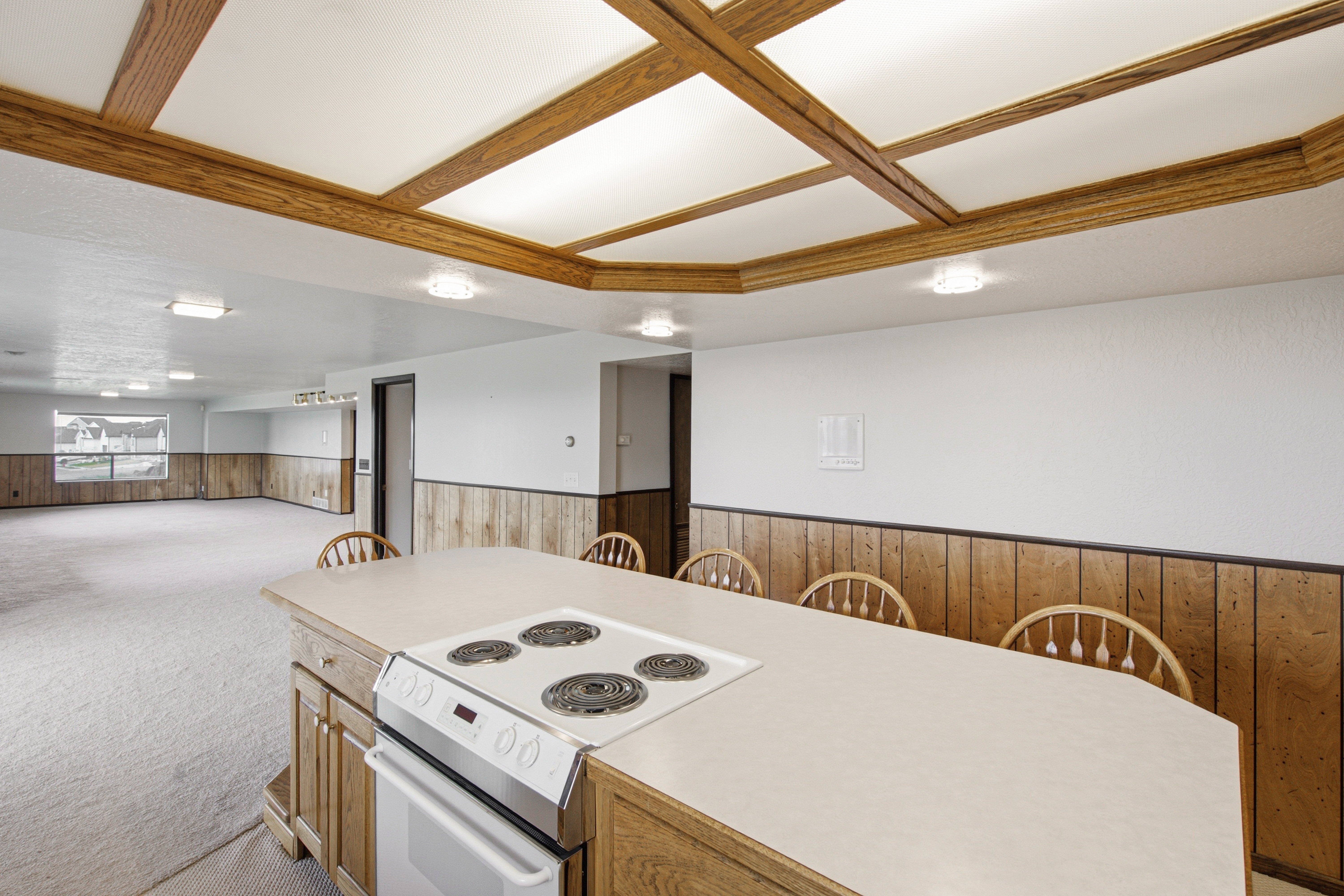 Kitchen island with an electric range and light-colored countertop