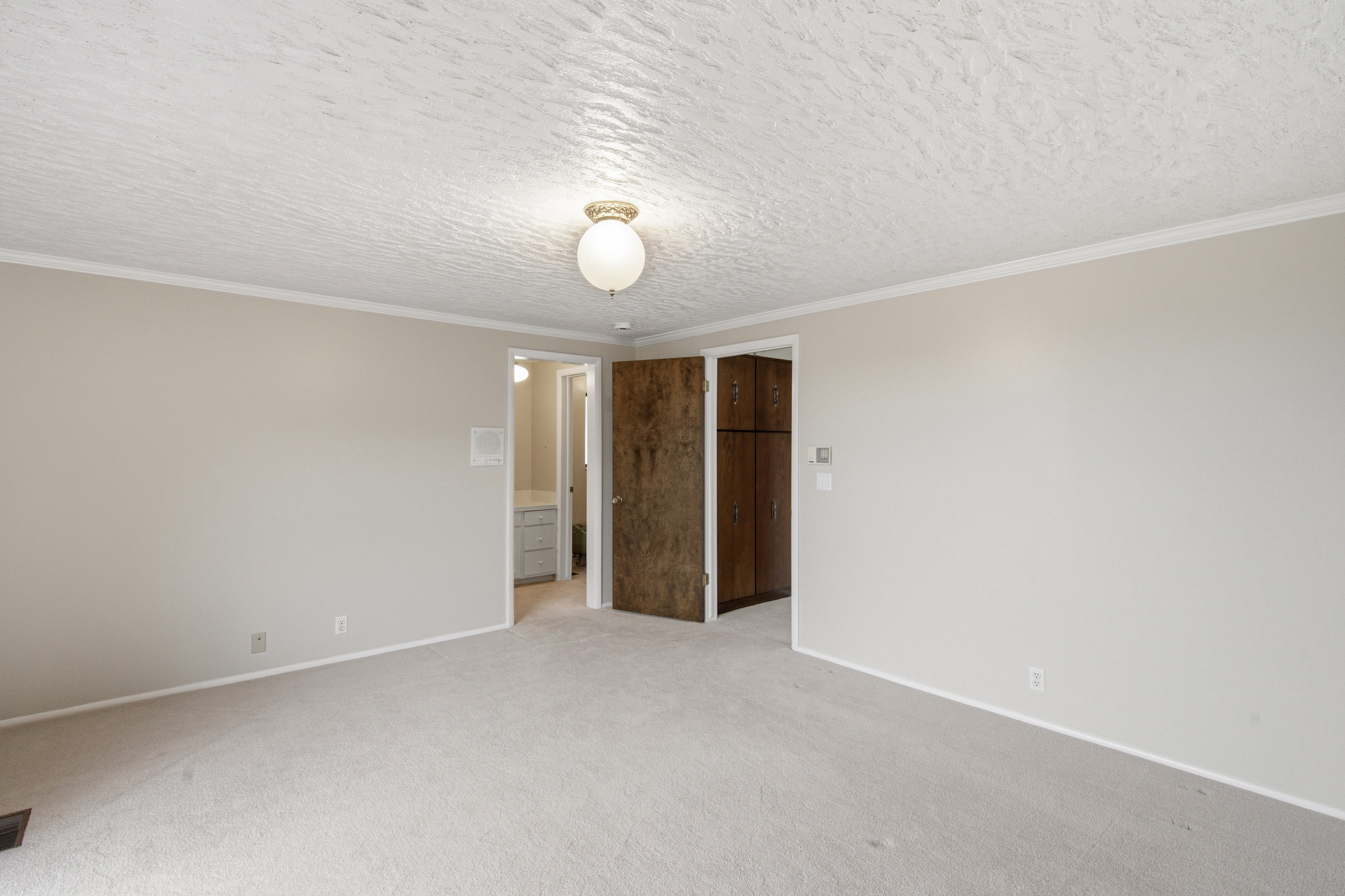 Carpeted room with light neutral walls and white trim
