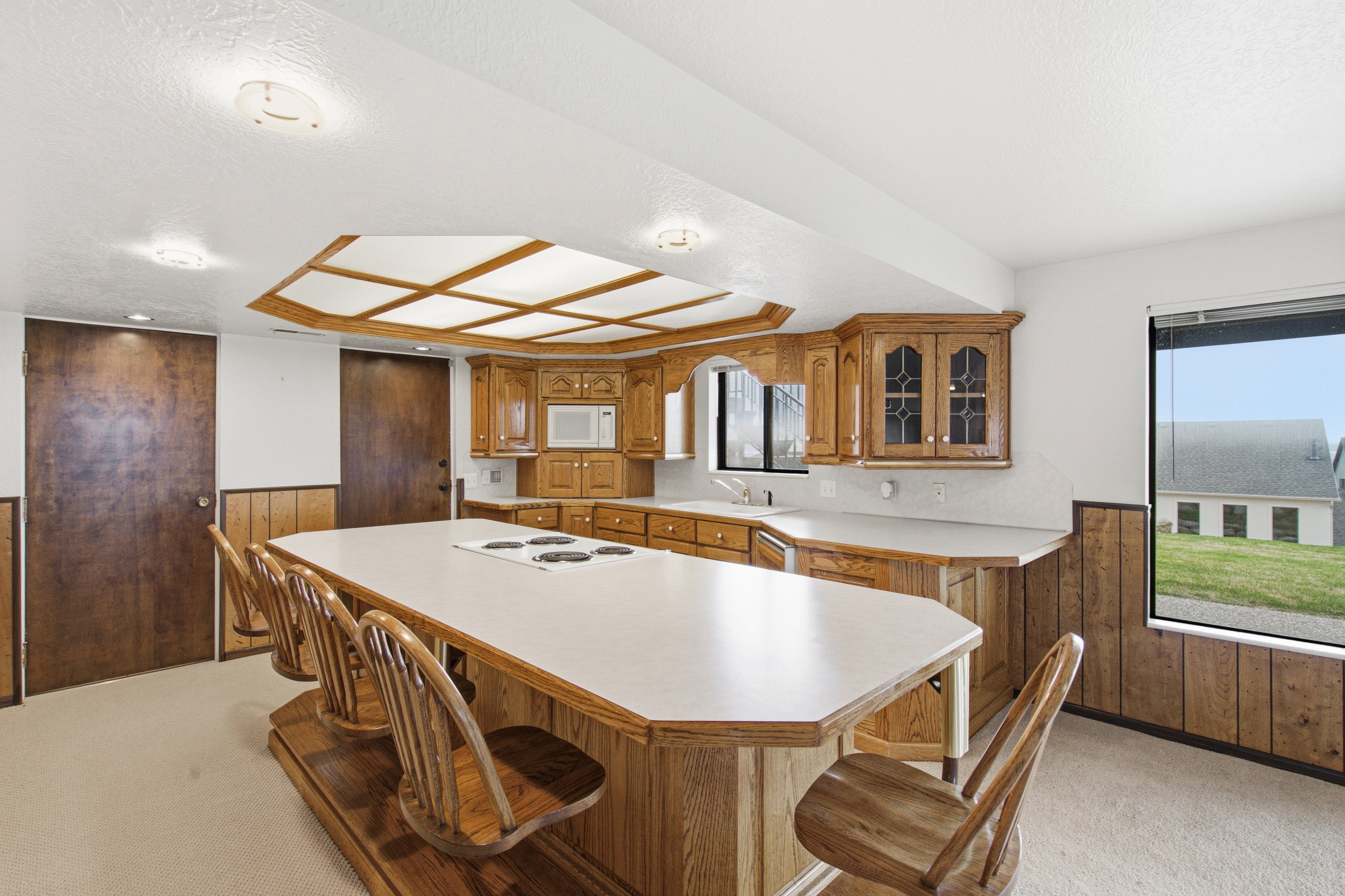 Expansive kitchen island with an integrated cooktop and seating for four