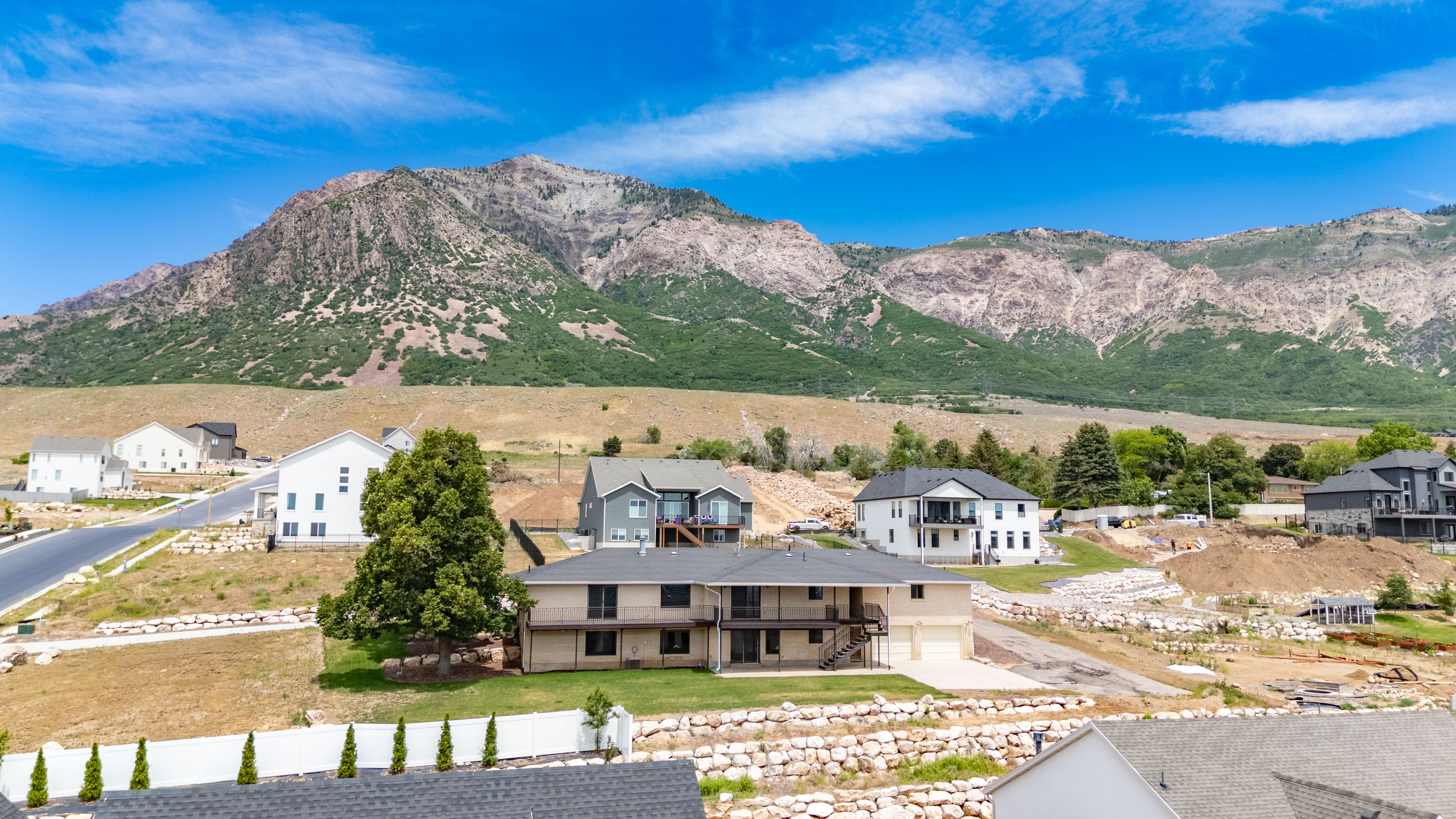 Expansive mountain backdrop framing a residential area with varied home styles