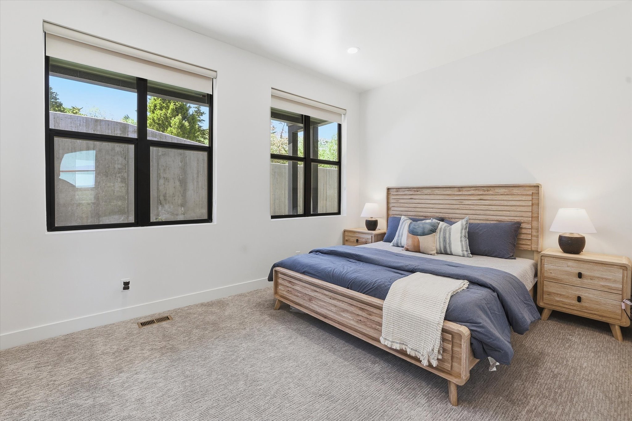 Spacious room featuring light-colored carpet flooring and white painted walls