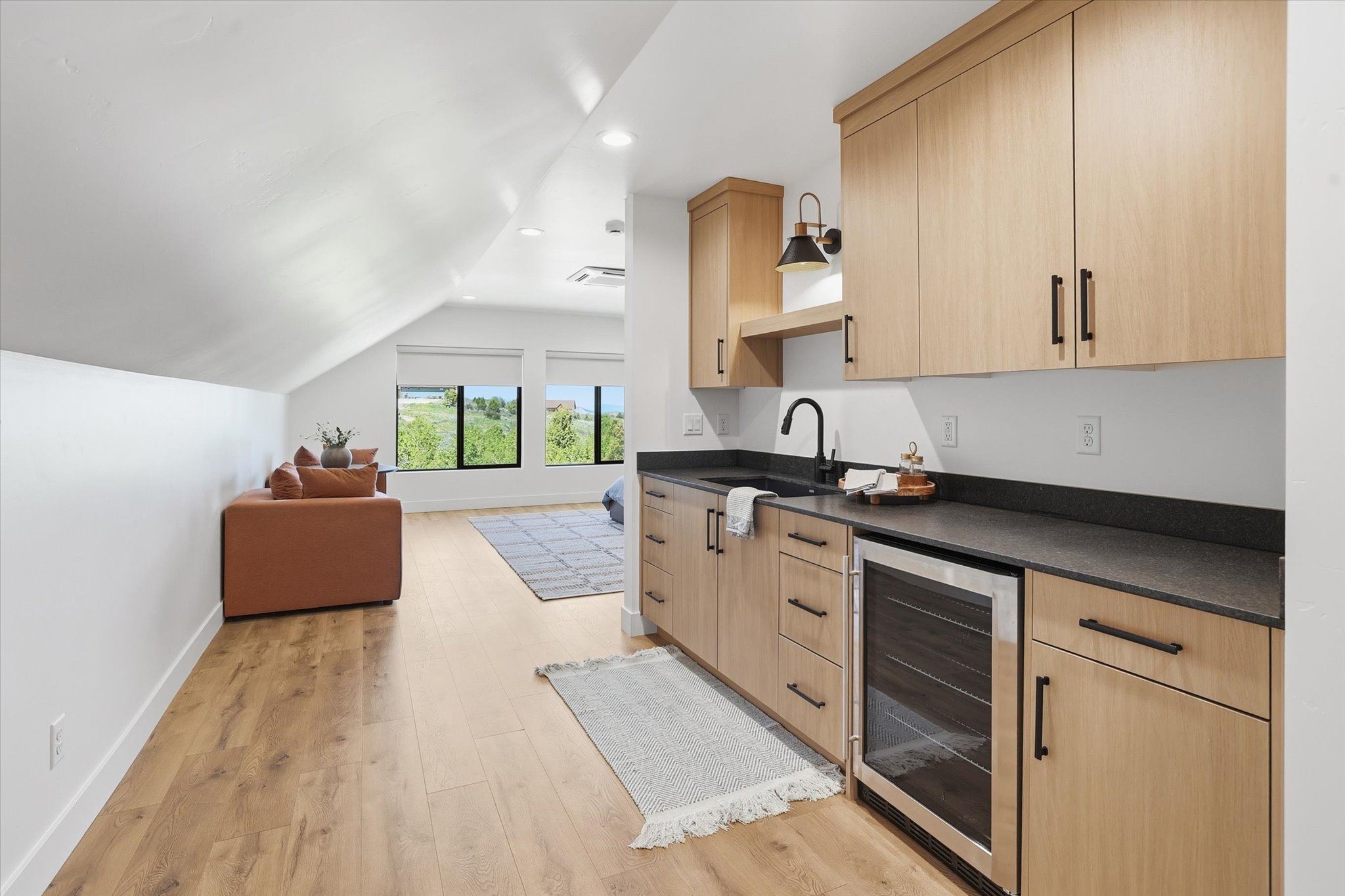 Attic space featuring wood-finish flooring, recessed lighting, and sloped ceilings