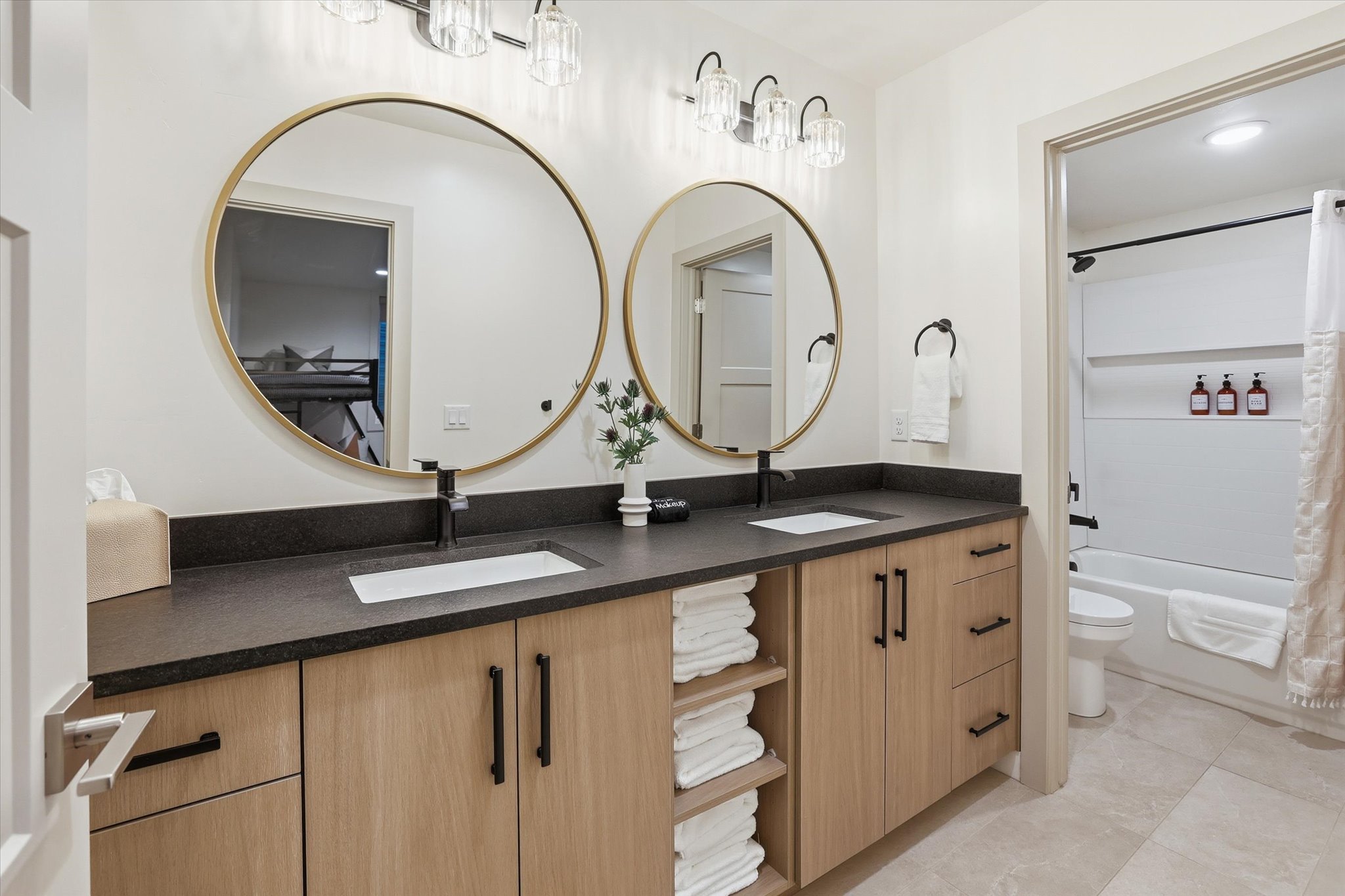 Dual vanity with a dark countertop and integrated rectangular sinks