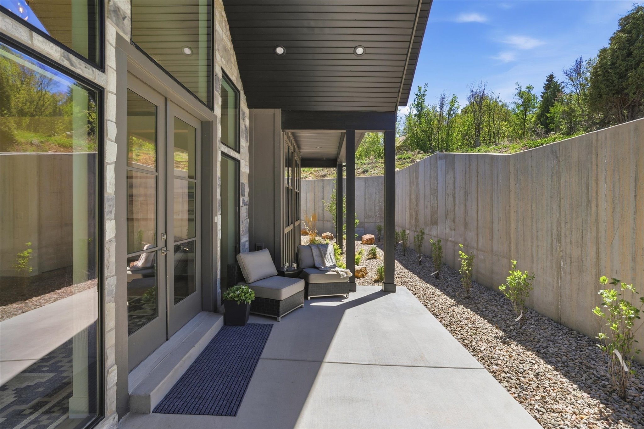 Covered patio featuring a concrete slab, recessed lighting, and a stone facade