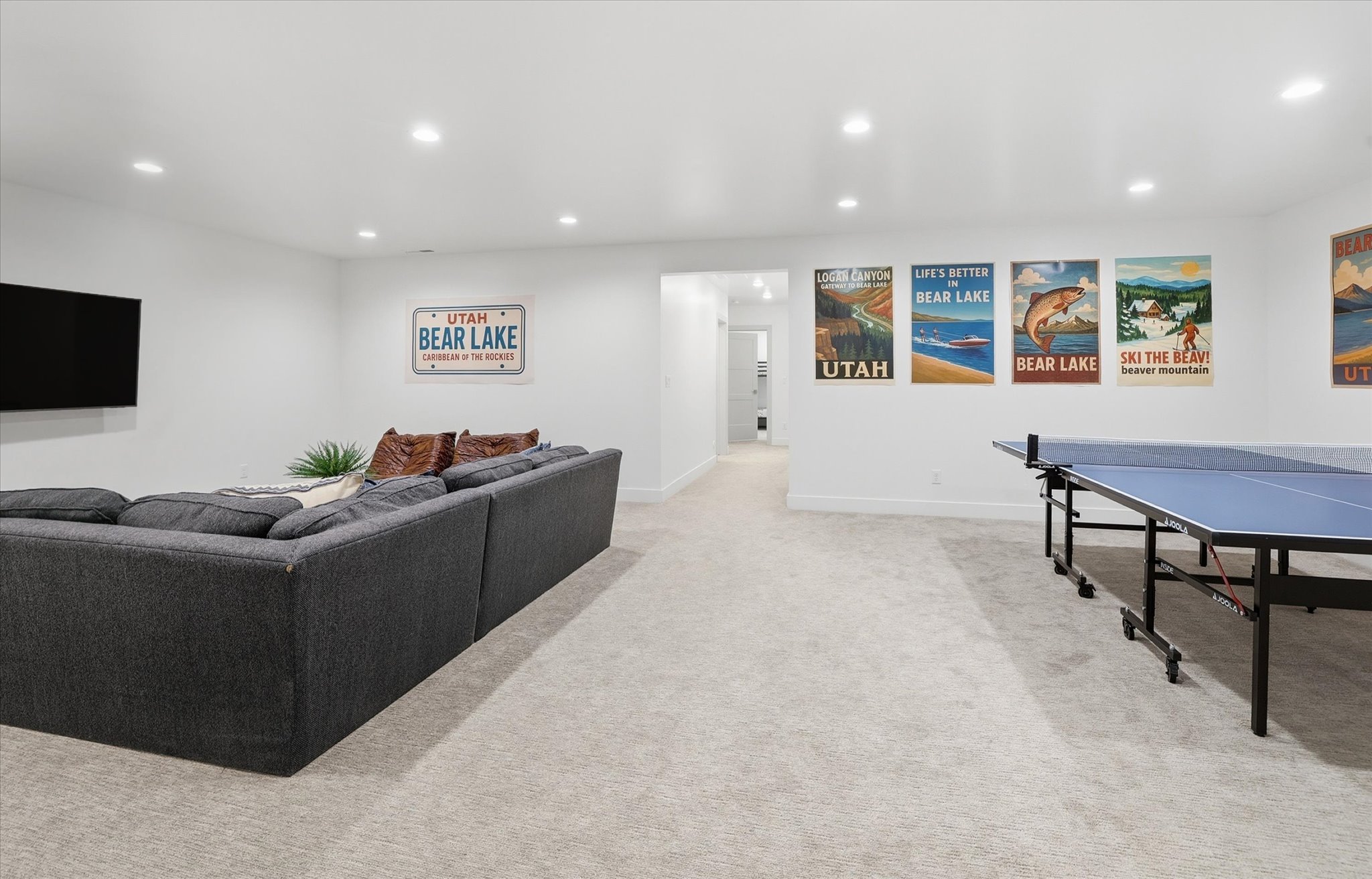 Spacious recreation area featuring recessed lighting, light-toned carpeting, and white painted walls