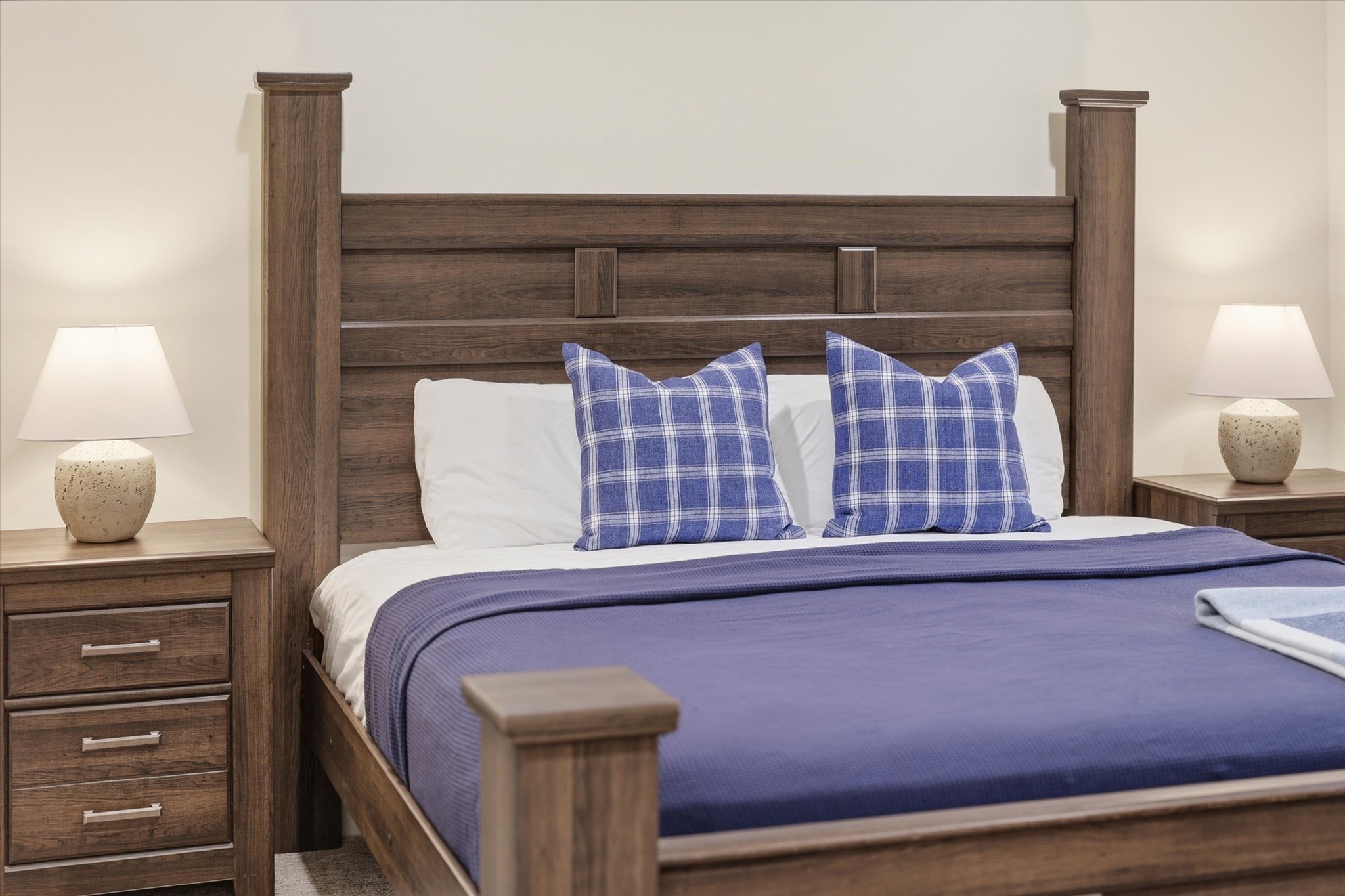Wood-finish bed frame with a slatted headboard and sturdy posts