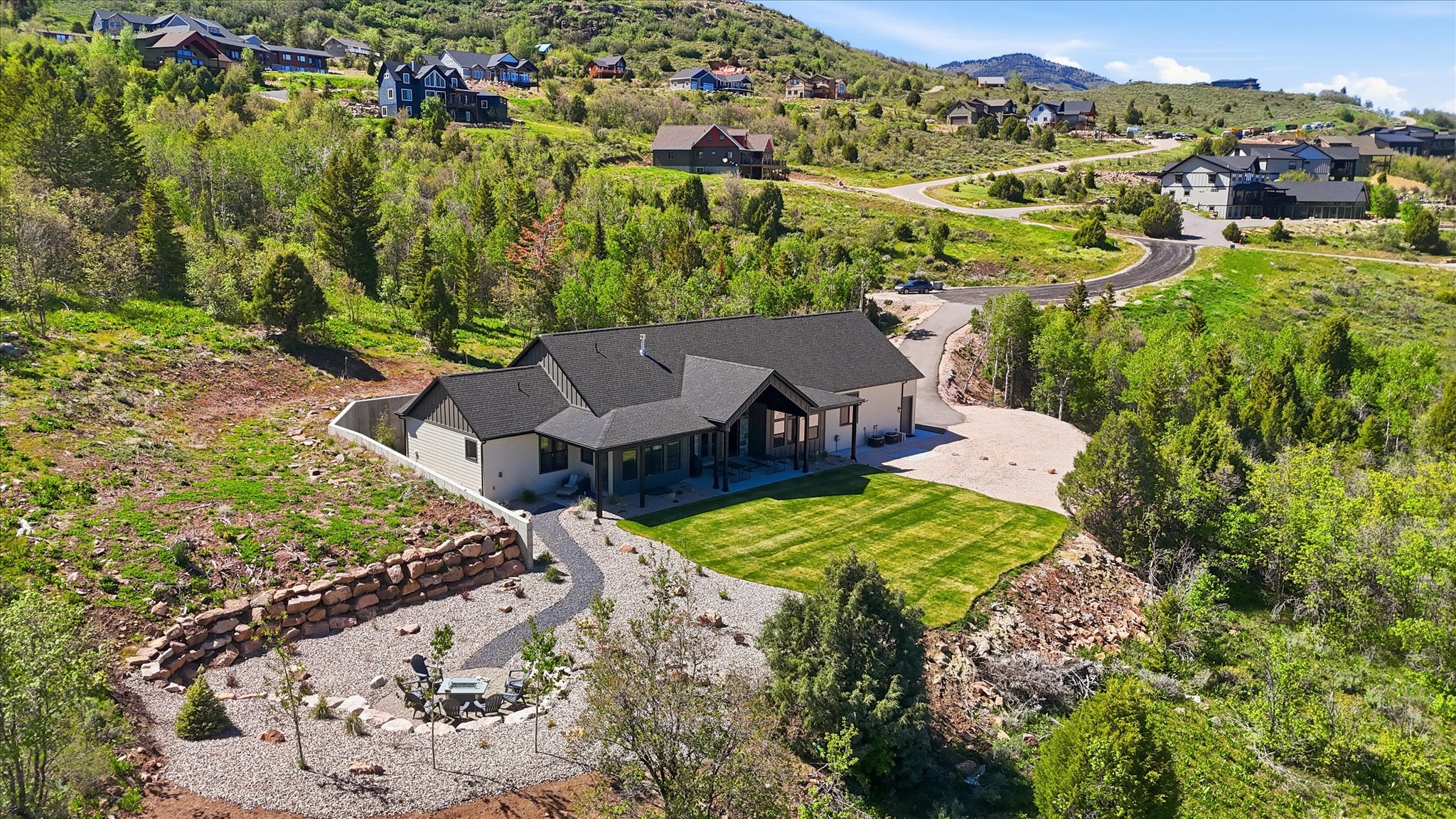 Modern ranch-style home featuring a dark shingle roof and light-toned siding