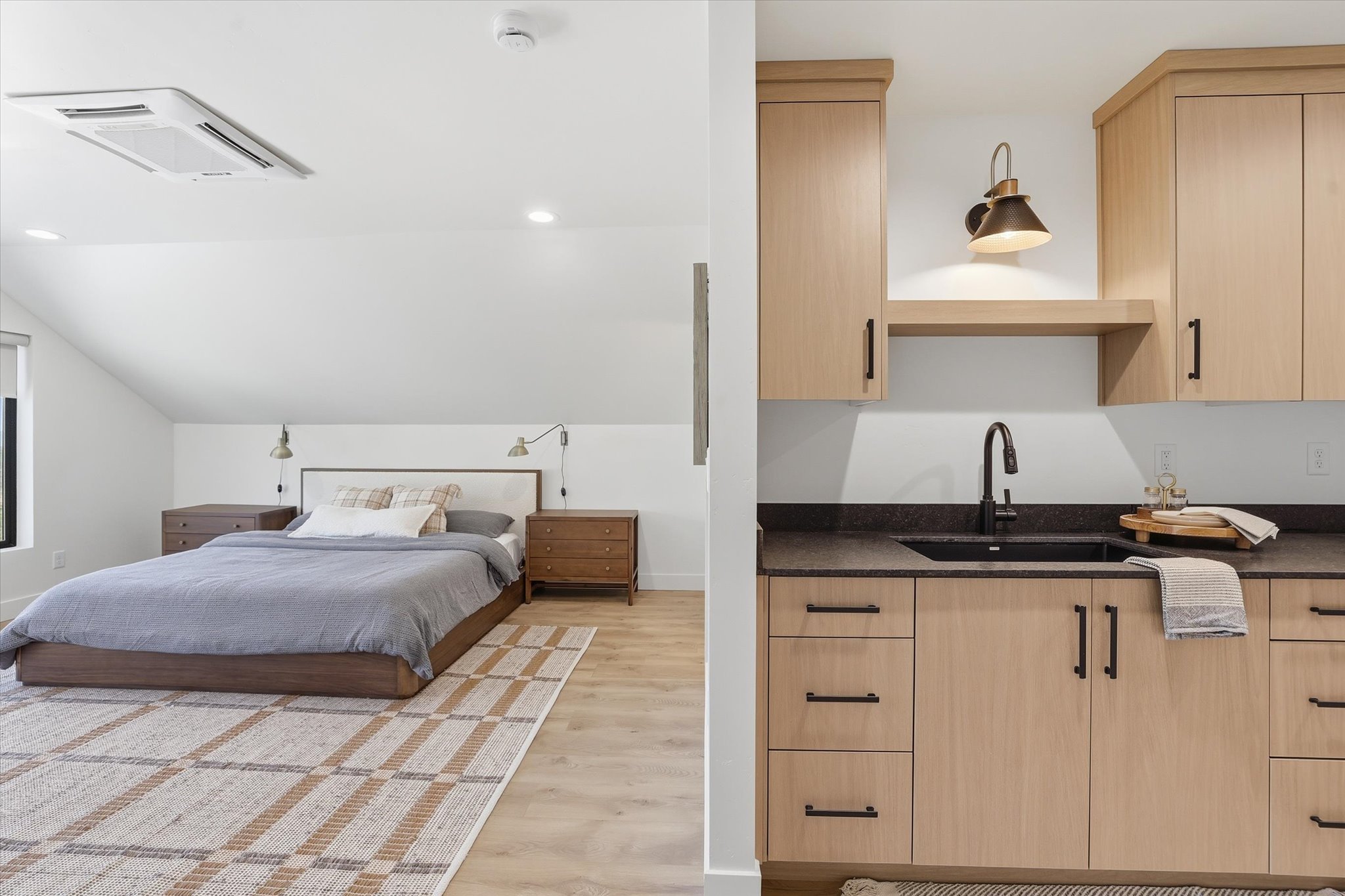 Attic space featuring a built-in wall unit with a sink, recessed lighting, and wood-finish flooring