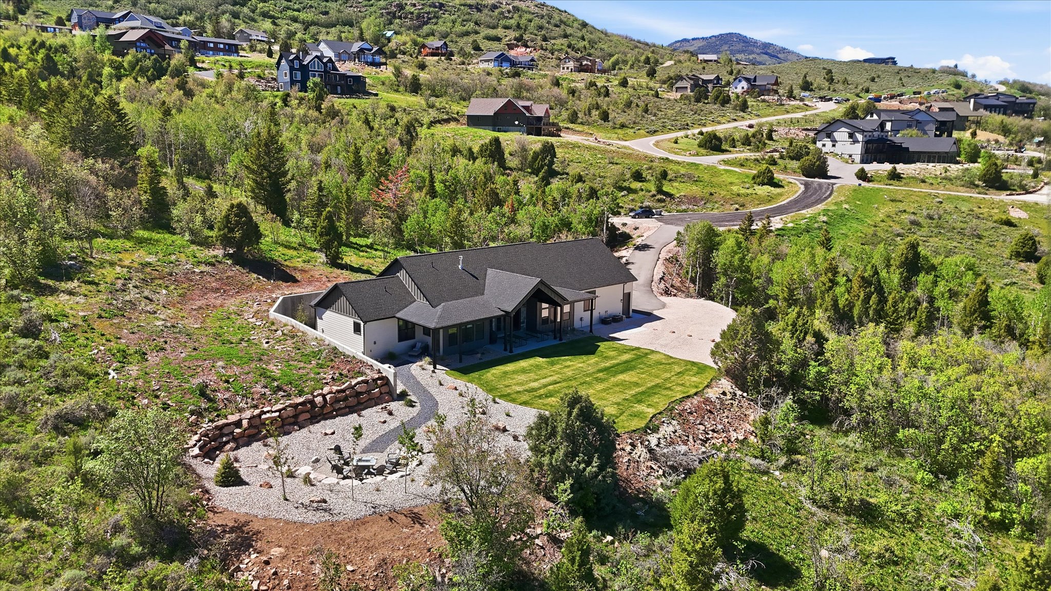 Contemporary single-story residence featuring a dark shingle roof and light-toned siding