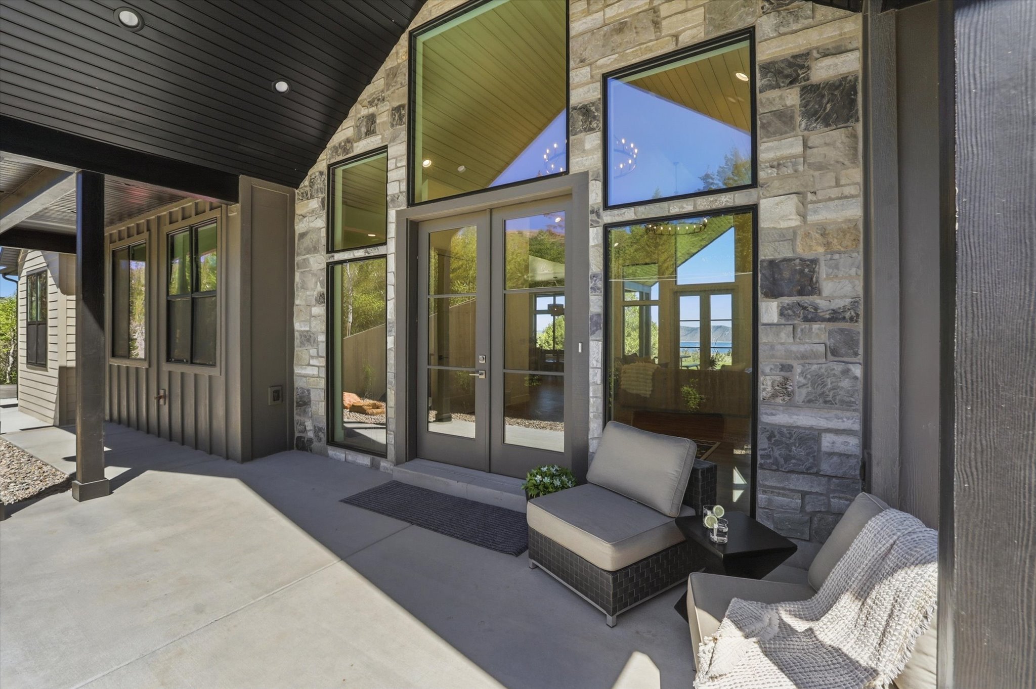 Stone and siding exterior with a covered concrete patio