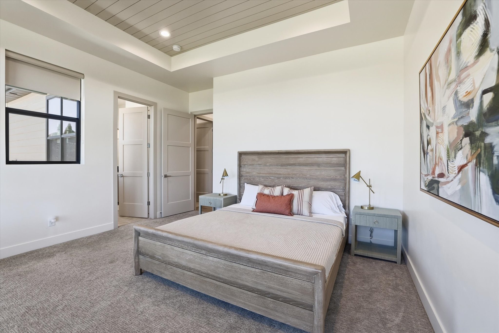 Recessed ceiling with shiplap detail, neutral wall paint, and gray carpet flooring