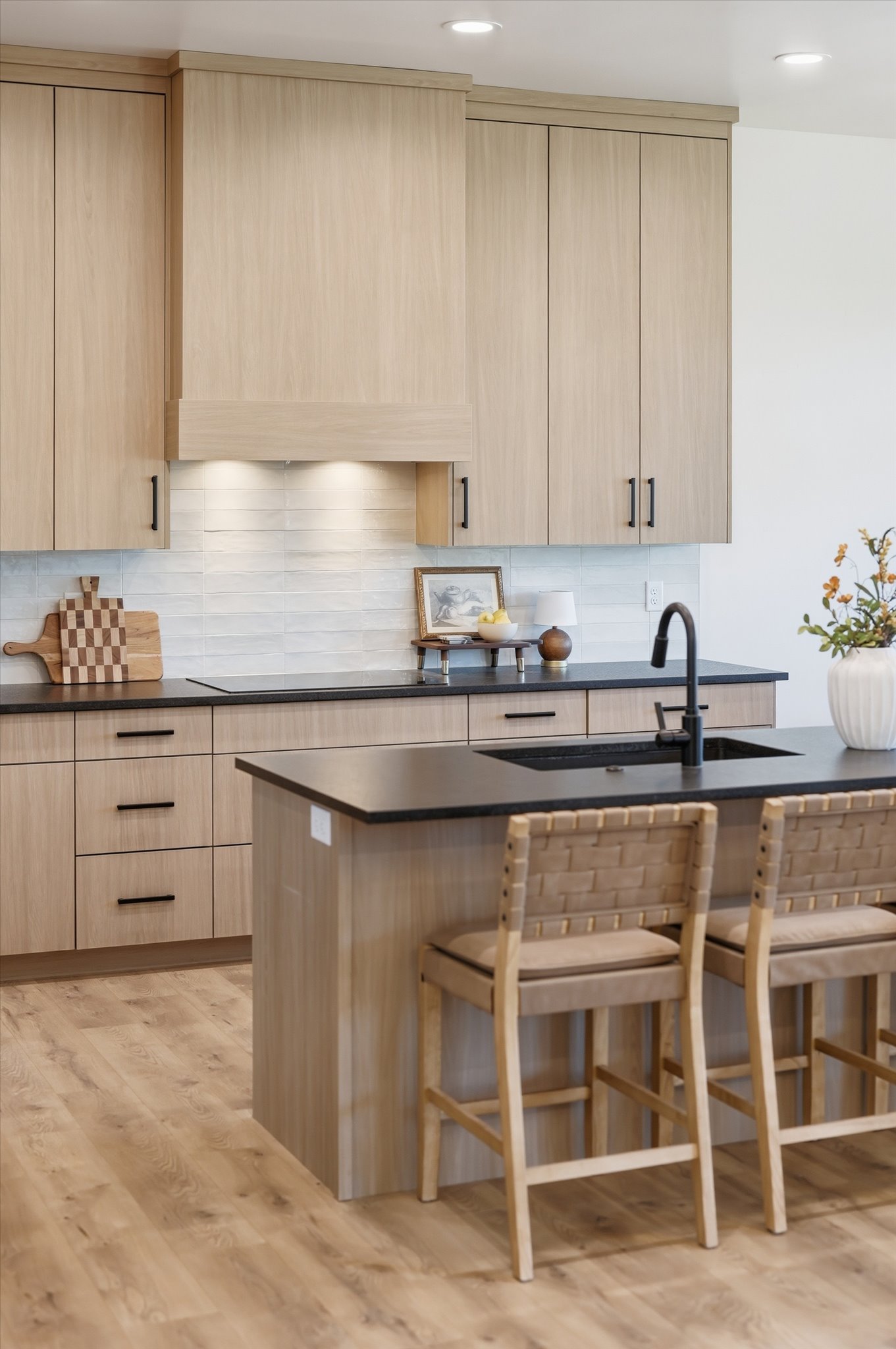 Contemporary kitchen featuring light wood-finish cabinetry and a matching island