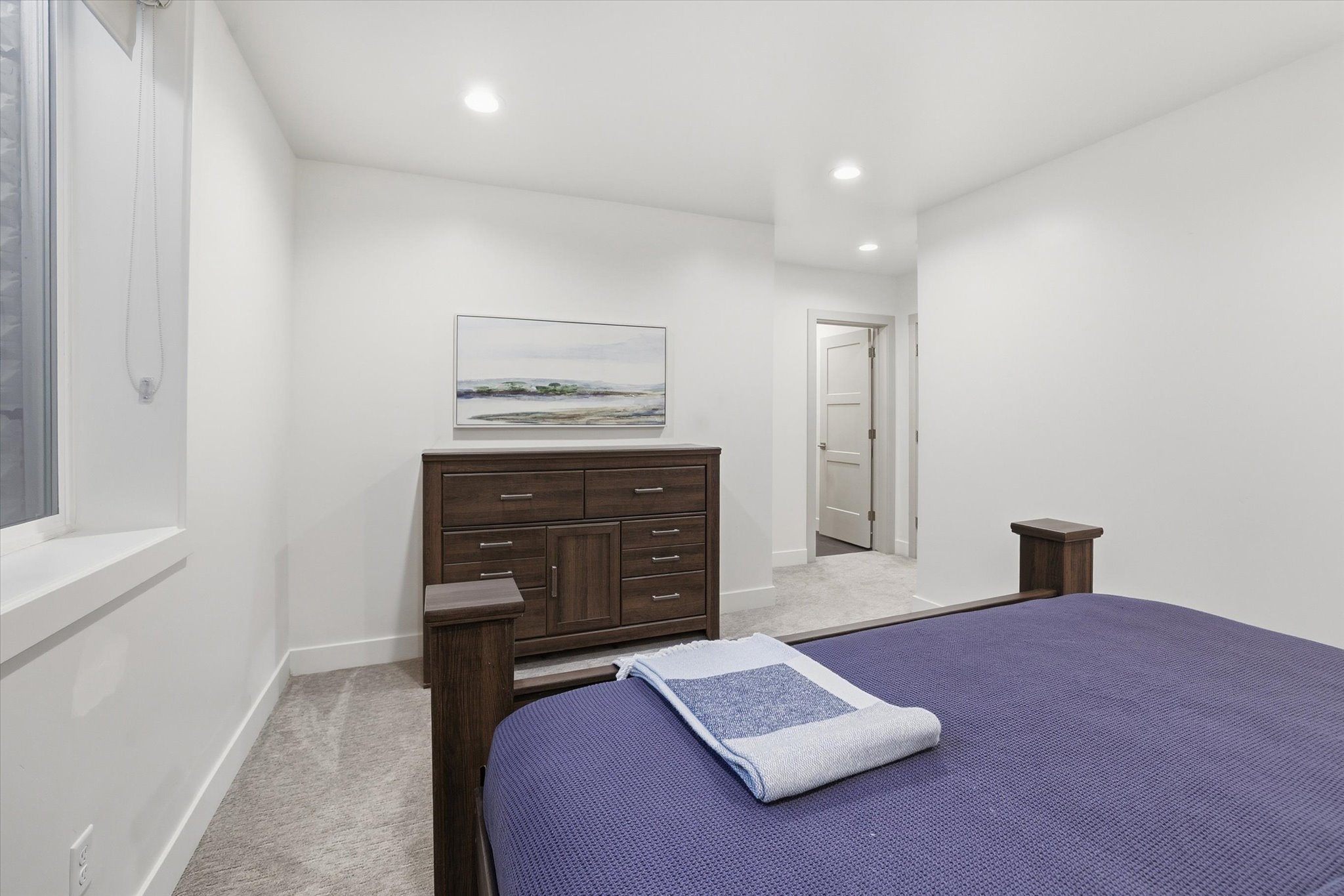 Bedroom featuring plush gray carpeting, recessed lighting, and crisp white walls