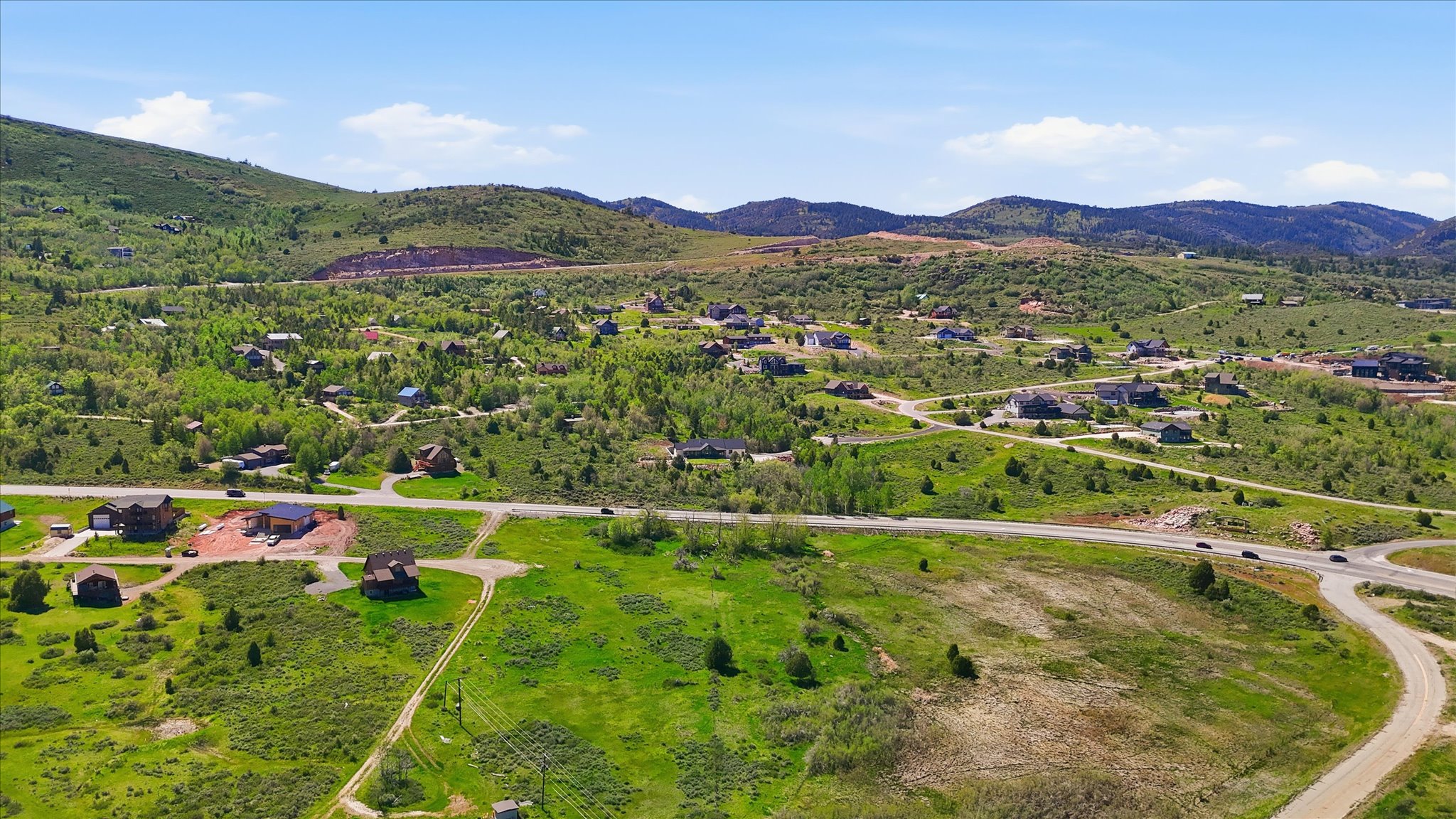 Expansive hillside property featuring established residential development, undeveloped land, and paved roads