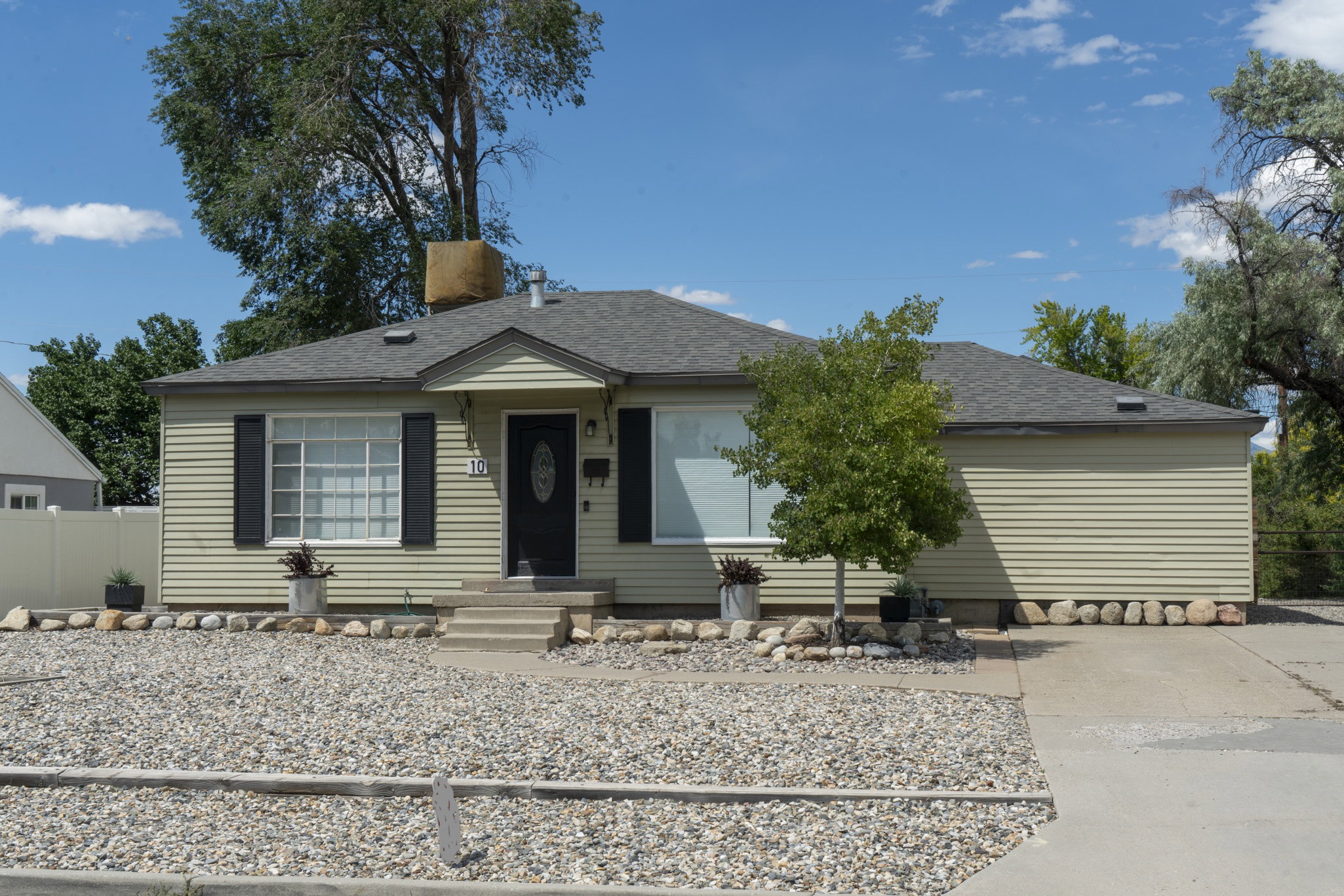 Single-story property featuring horizontal siding and a dark shingled roof