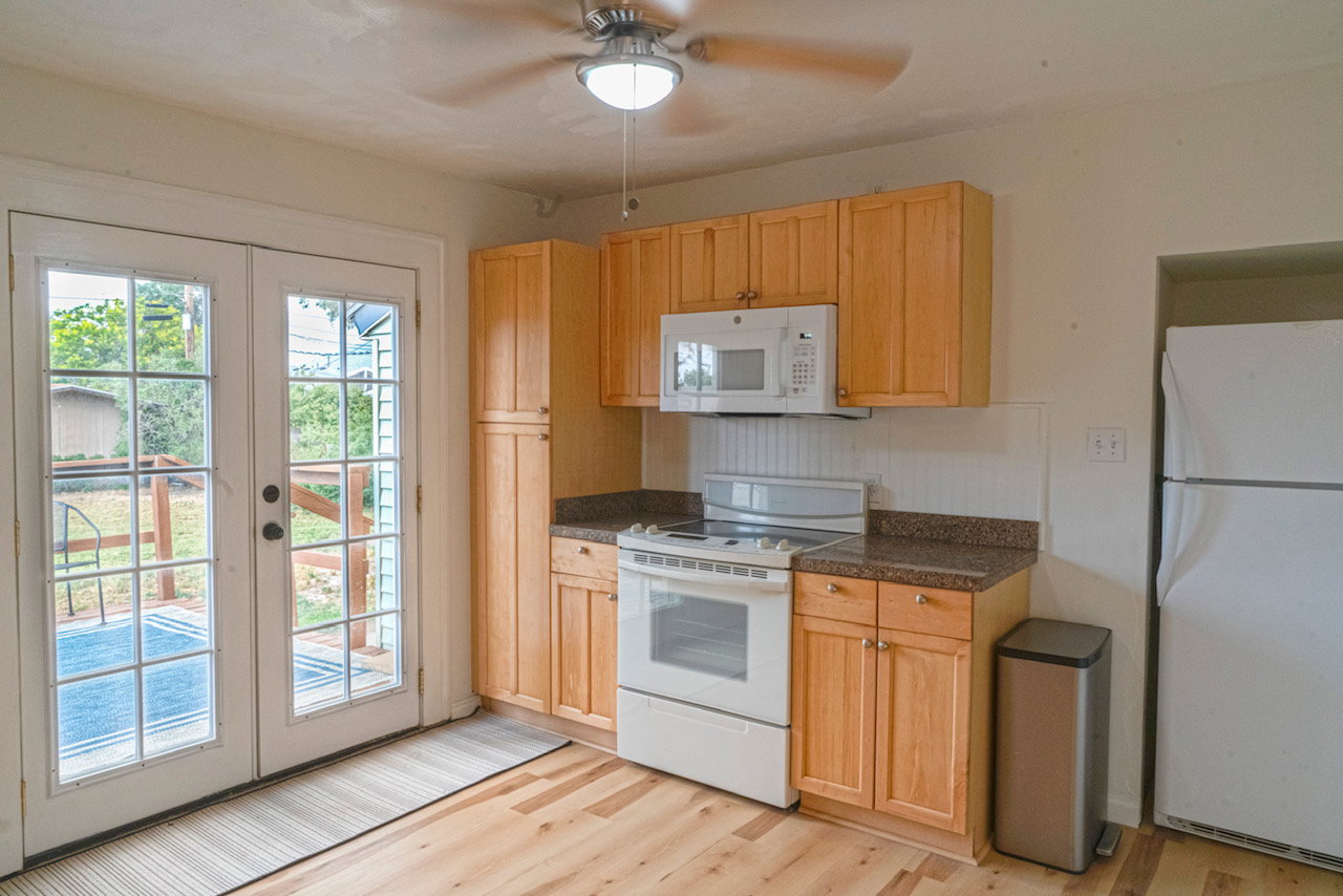 Kitchen with wood-finish flooring and light wood cabinetry