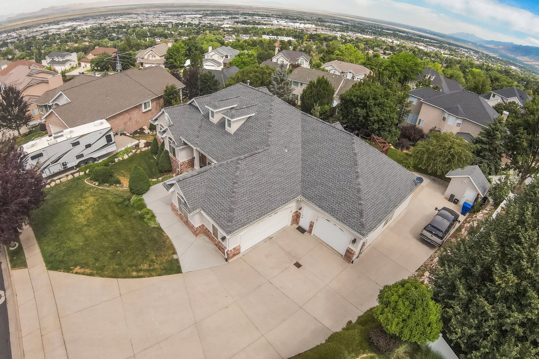 Expansive residential property featuring a multi-gabled roofline and a brick and siding exterior