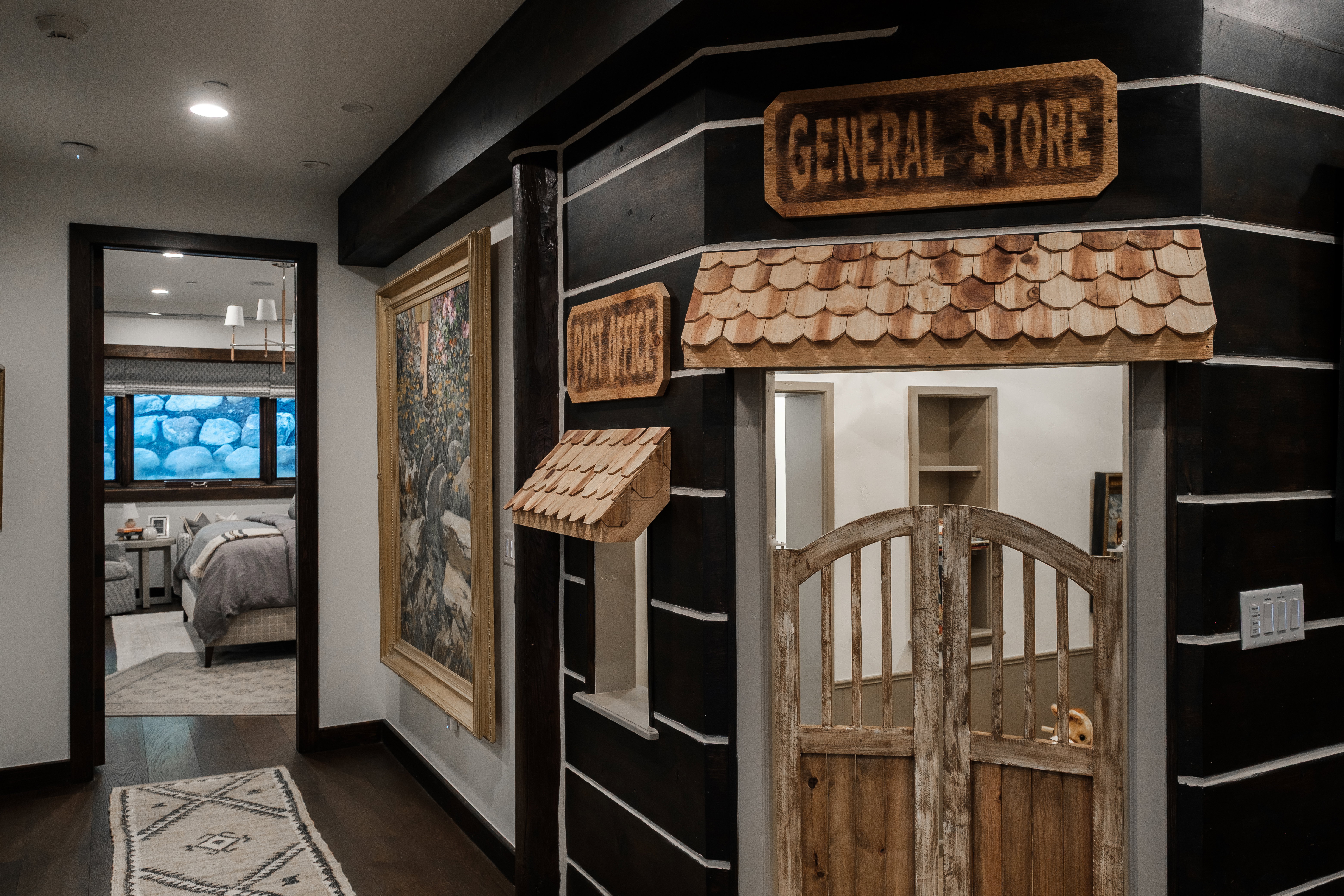 Hallway featuring dark wood-finish flooring, recessed lighting, and a unique "General Store" facade with a wood shingle awning and rustic saloon-style doors